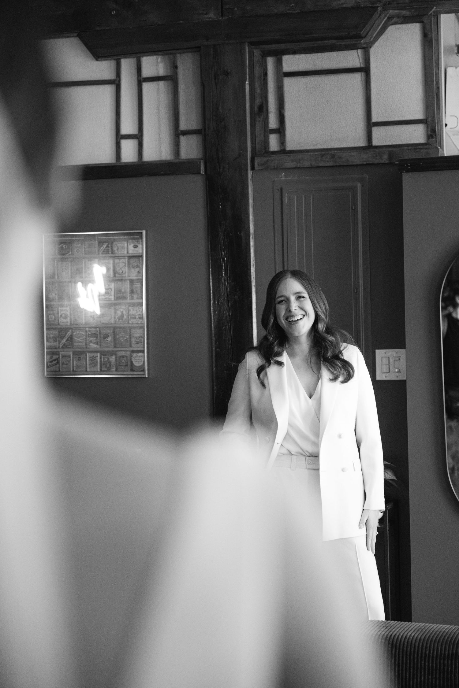 Black and white interior shots with soft window lighting in an urban space.