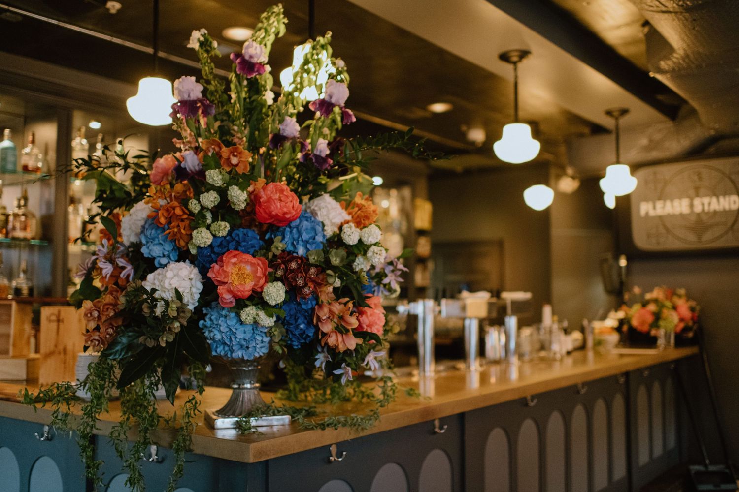 large floral centerpiece on bar