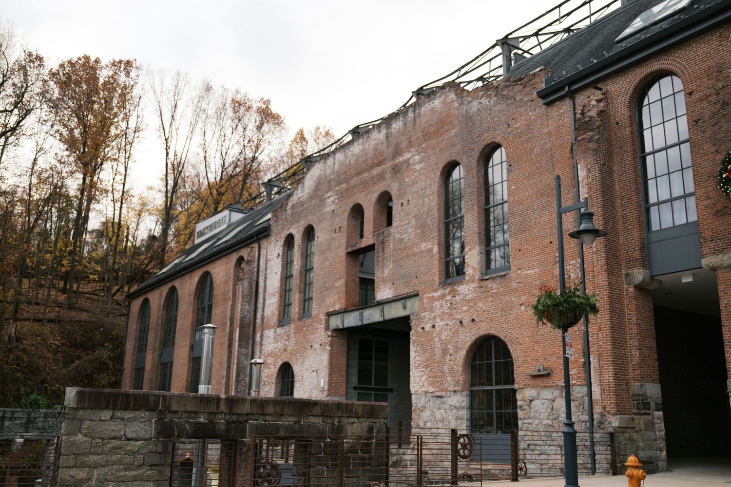 Historic brick building with arched windows and industrial architectural details.