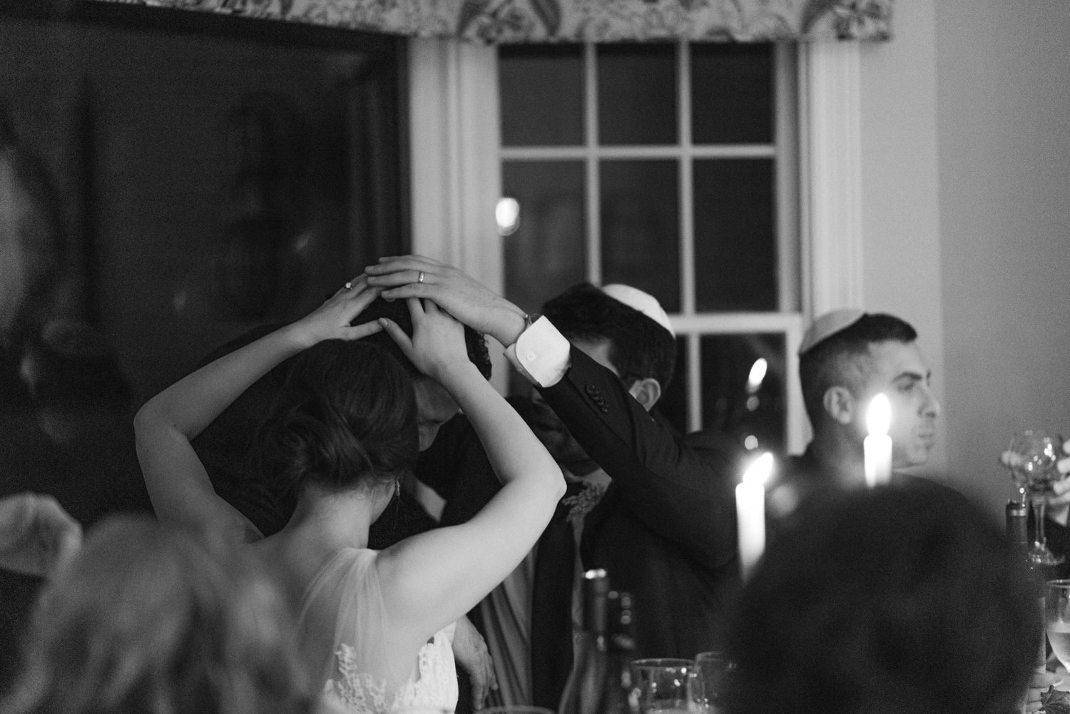Black and white photo of wedding reception celebration with dancing guests.