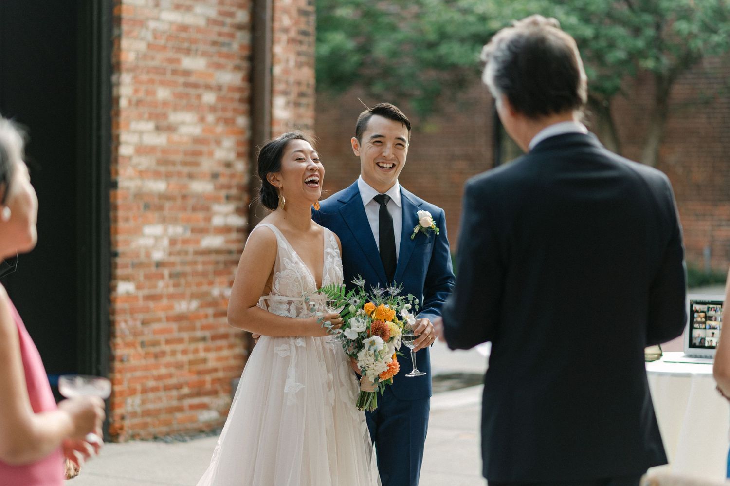 bride and groom laugh during toasts