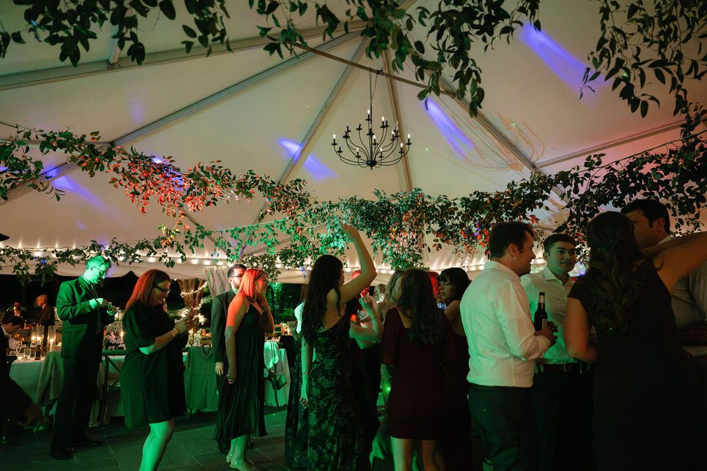 Party venue decorated with string lights and greenery creates an atmospheric evening ambiance at Strong Mansion on Sugarloaf Mountain