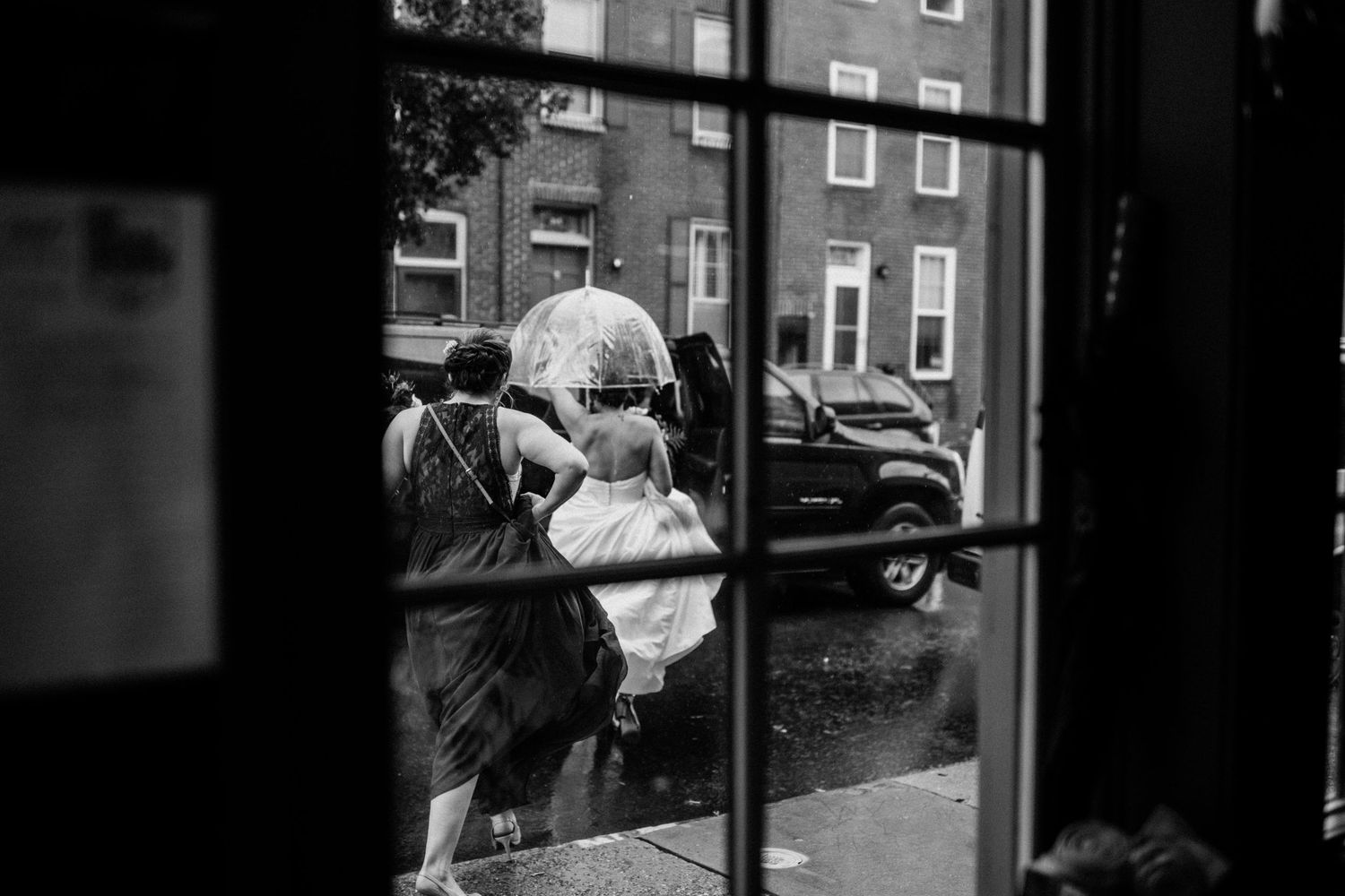 Urban street scene viewed through a window on a rainy day.
