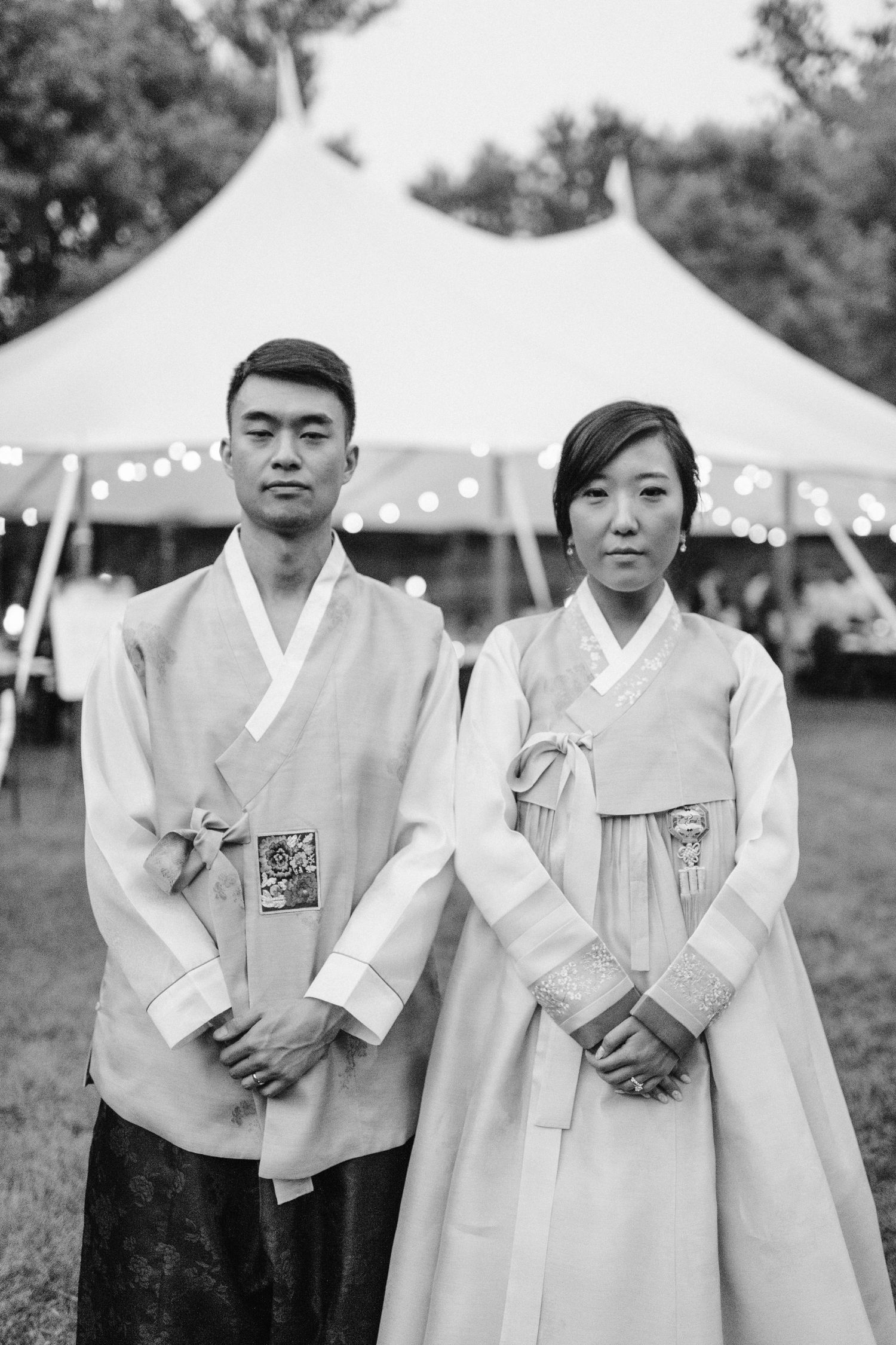 Group wearing traditional Korean hanbok formal attire at outdoor event.