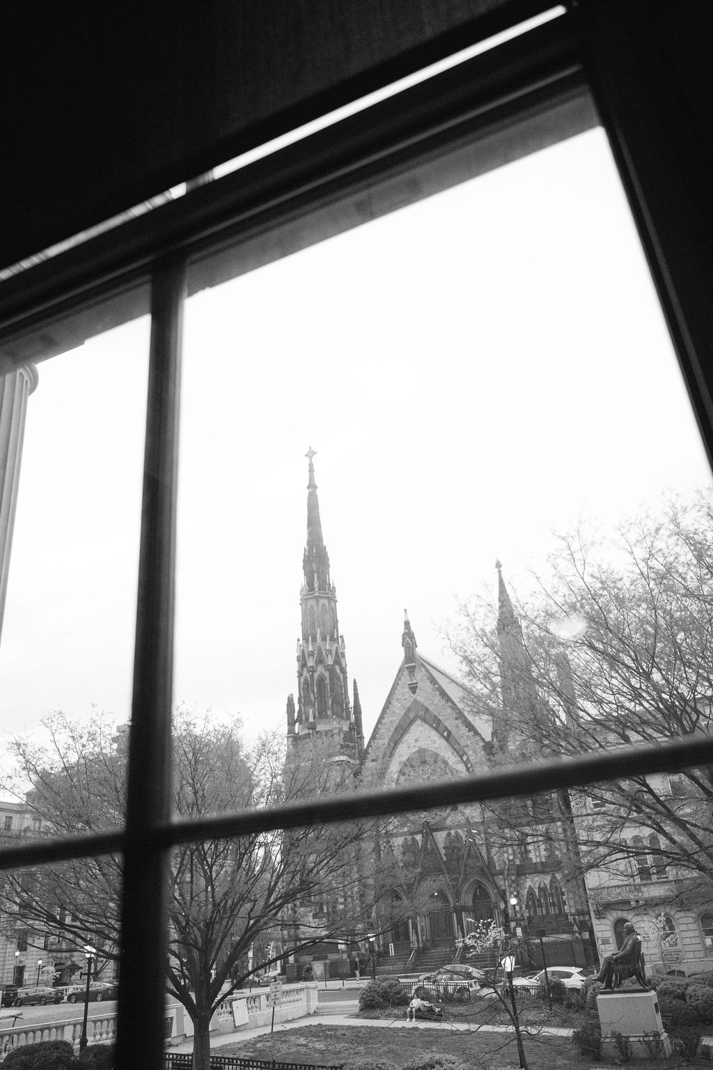 View of church spires and gothic architecture through a window frame.