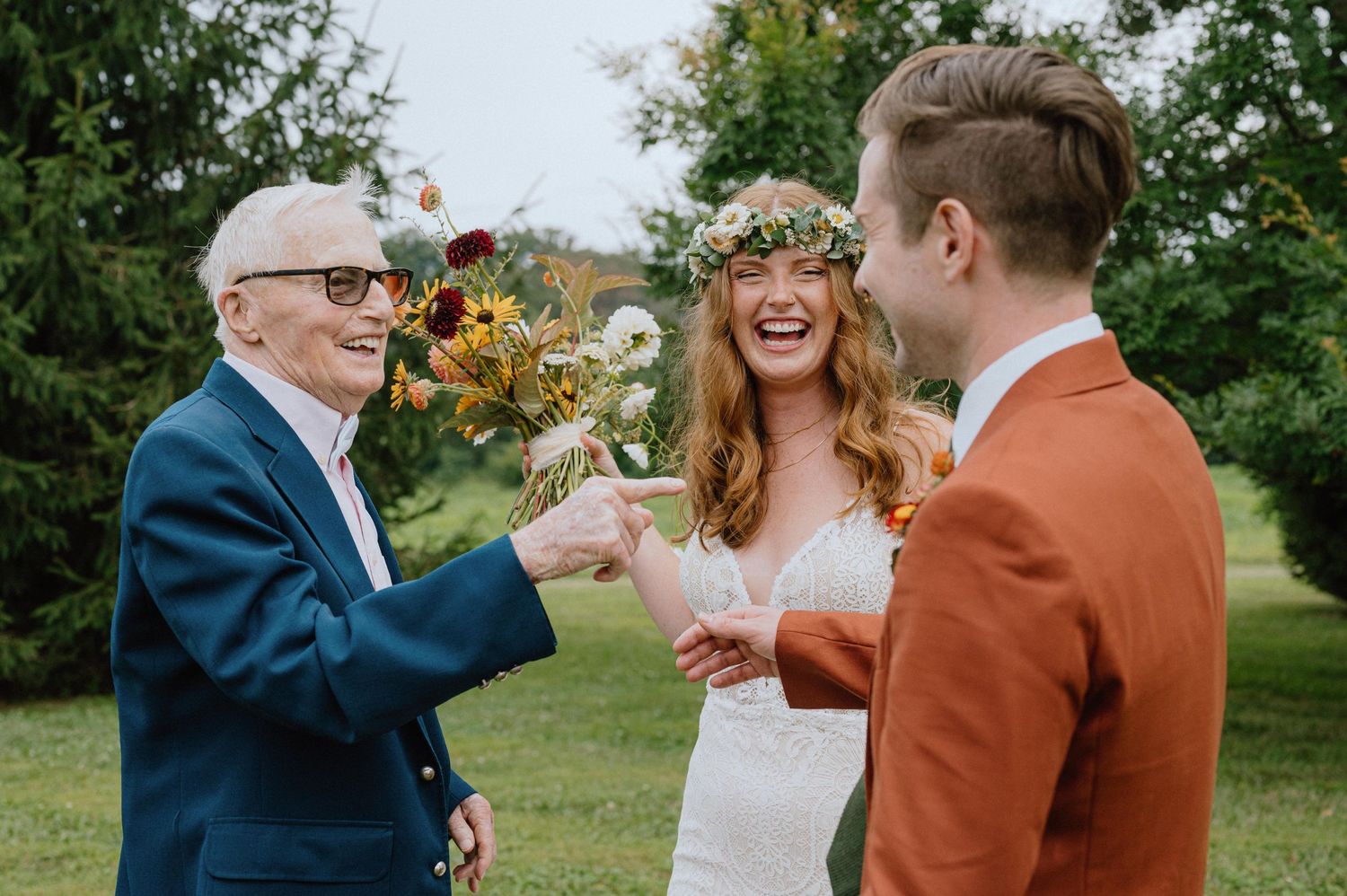 bride and groom laugh with grandfather candid image backyard wedding maryland documentary wedding photographer
