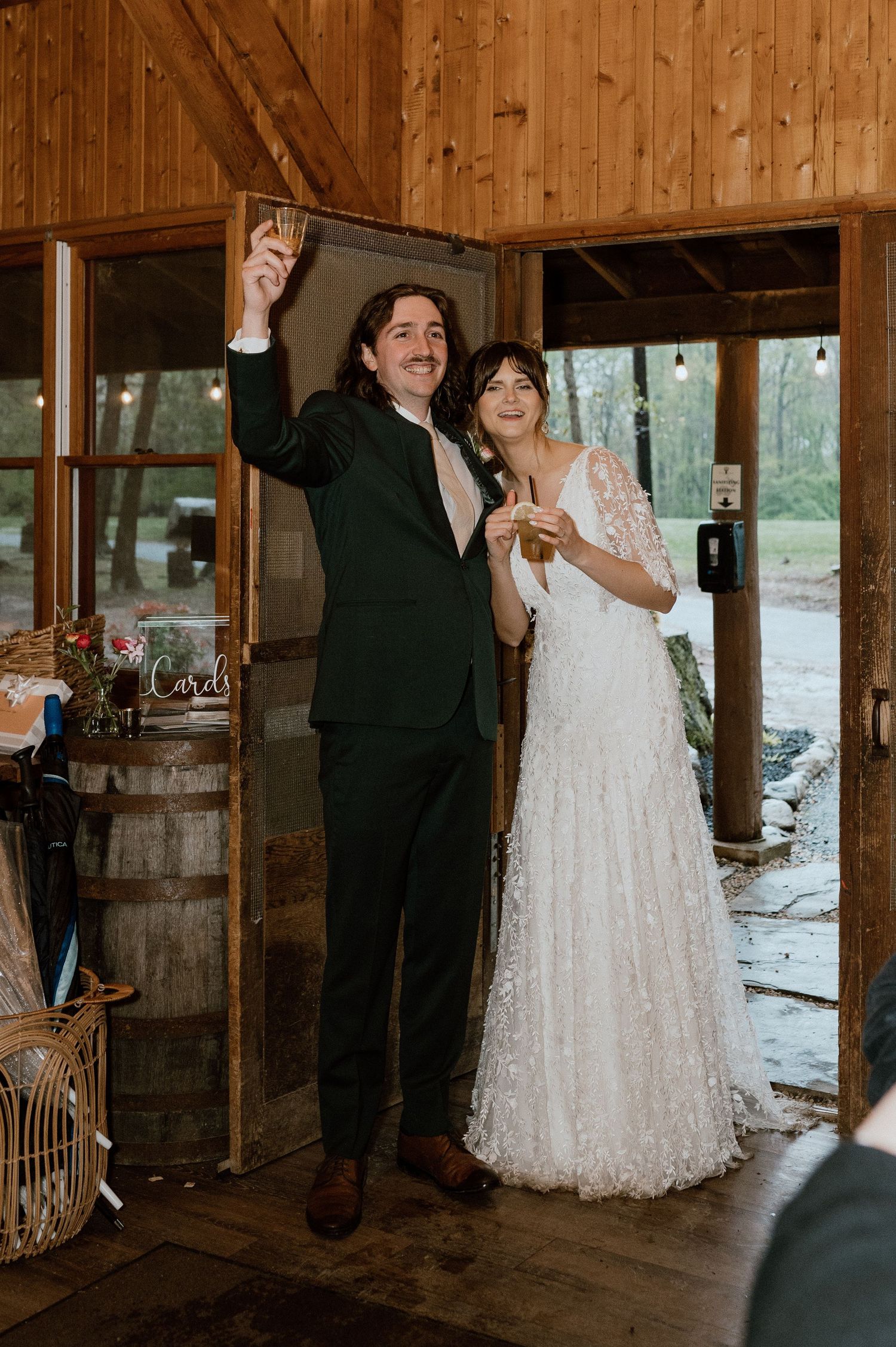 A celebratory moment captured inside a rustic wooden venue during a wedding reception.