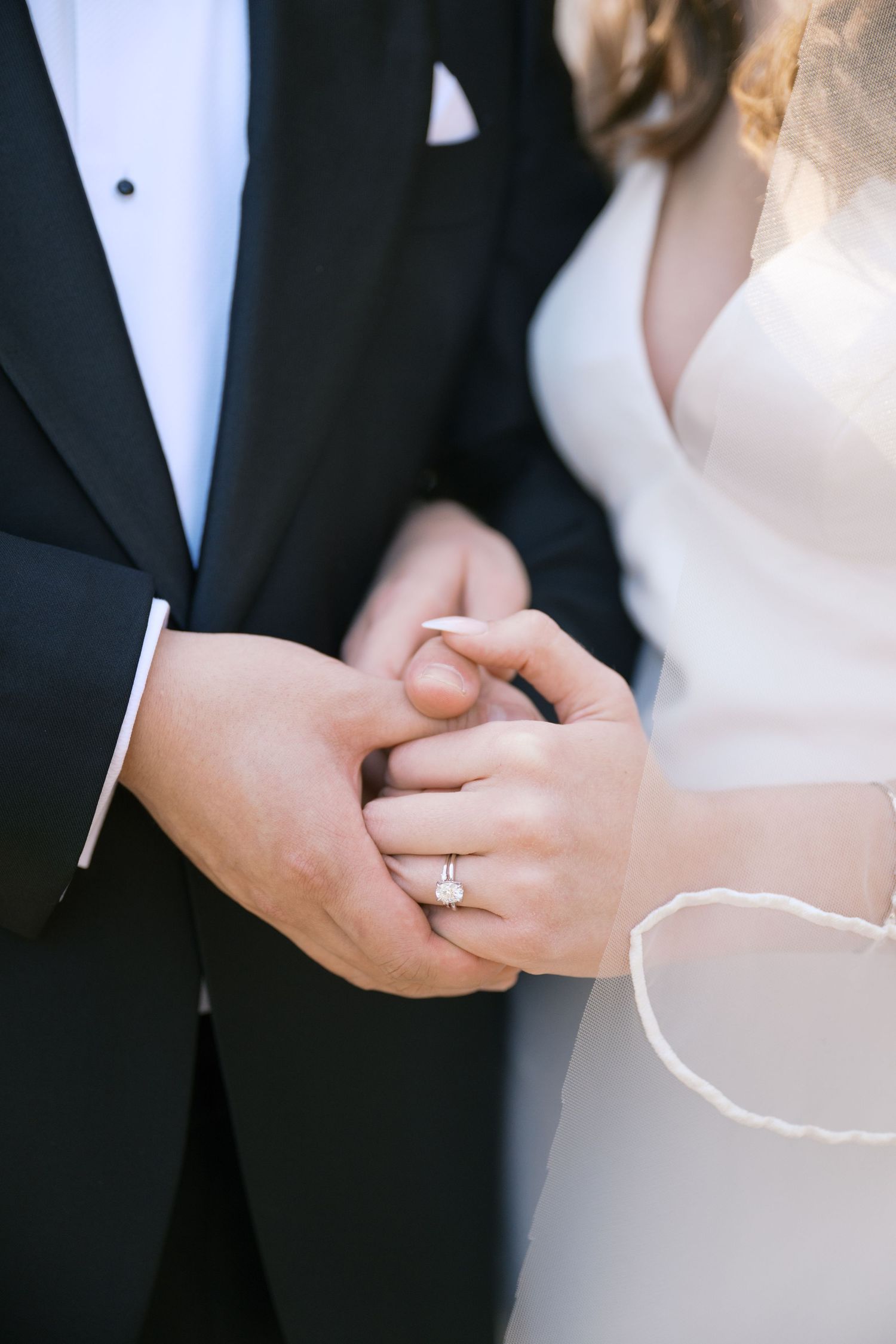 Close-up of hands exchanging rings during an elegant wedding ceremony.