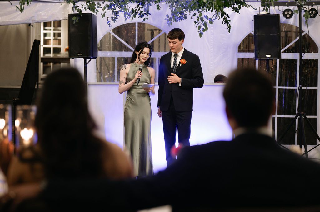 Evening wedding ceremony space with soft lighting and white draping.