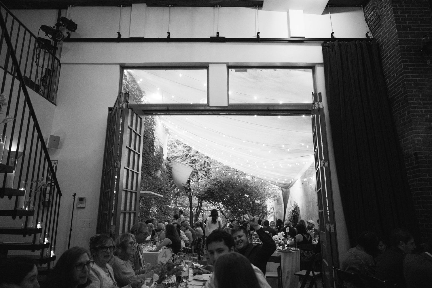 Black and white panoramic sequence showing interior staircase and windows.