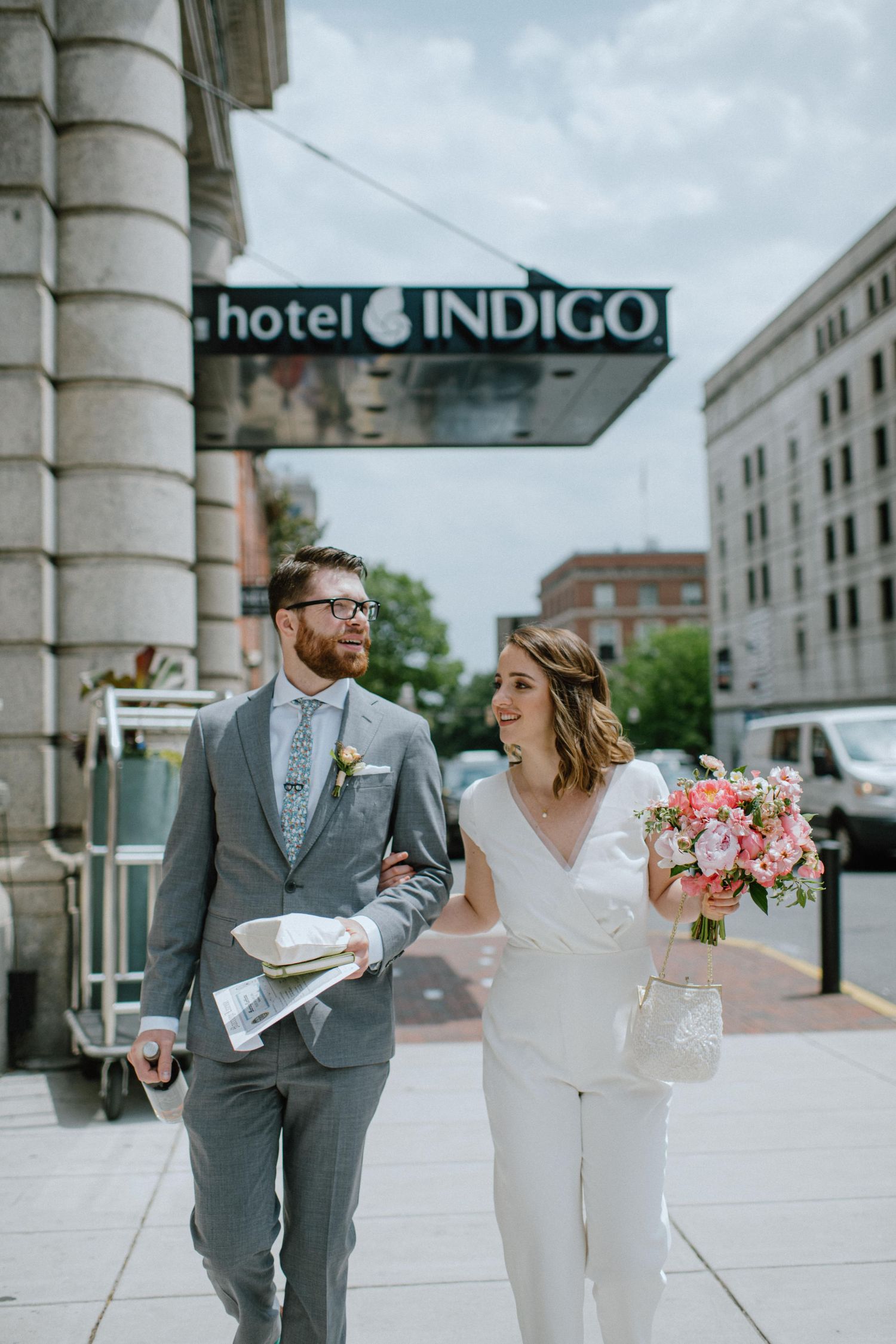 bride and groom walking down the street in baltimore