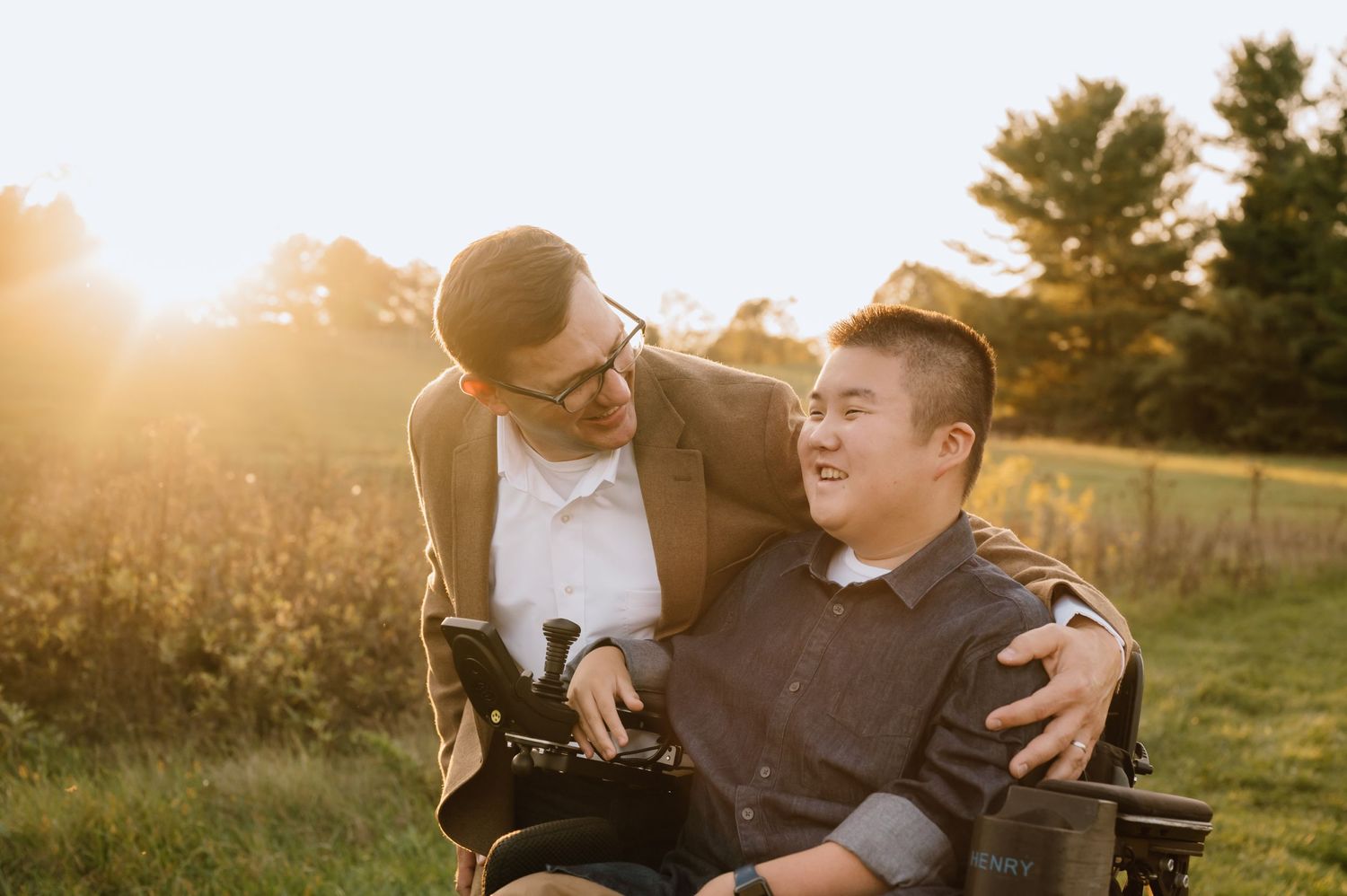 Intimate outdoor portrait capturing a tender moment between two people at sunset.