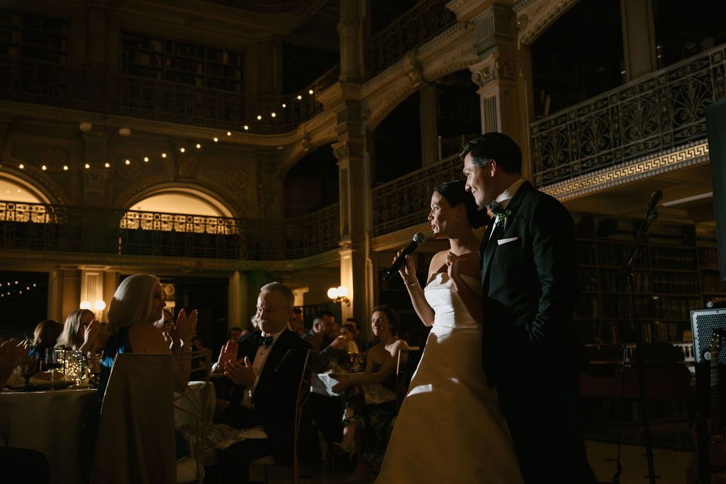 Wedding reception dance captured in dramatic lighting with architectural details visible at George Peabody Library Wedding in Baltimore