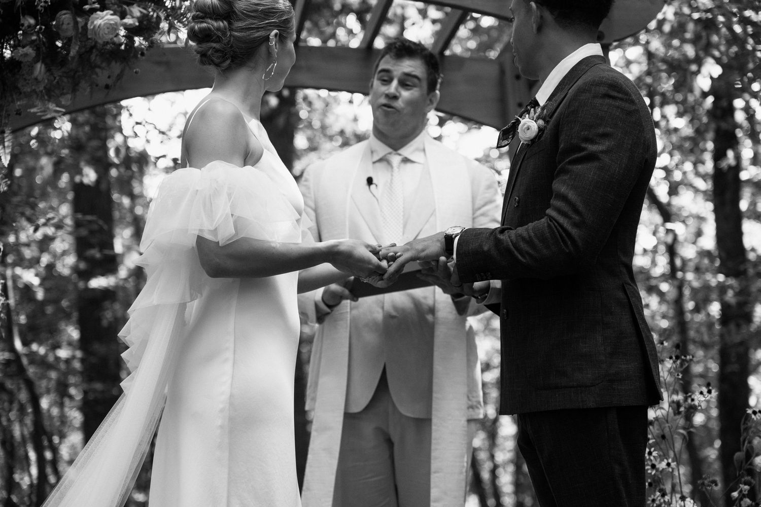 Wedding ceremony taking place in a lush outdoor garden setting.