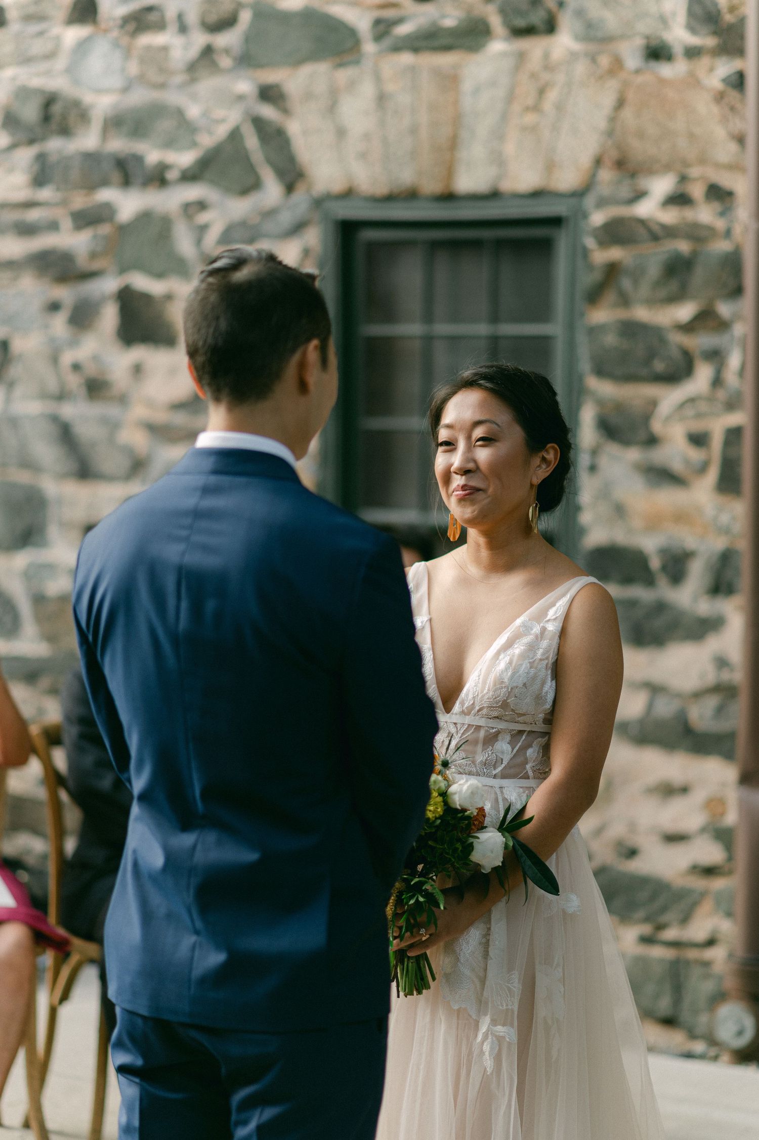 bride smiles at groom during wedding ceremony