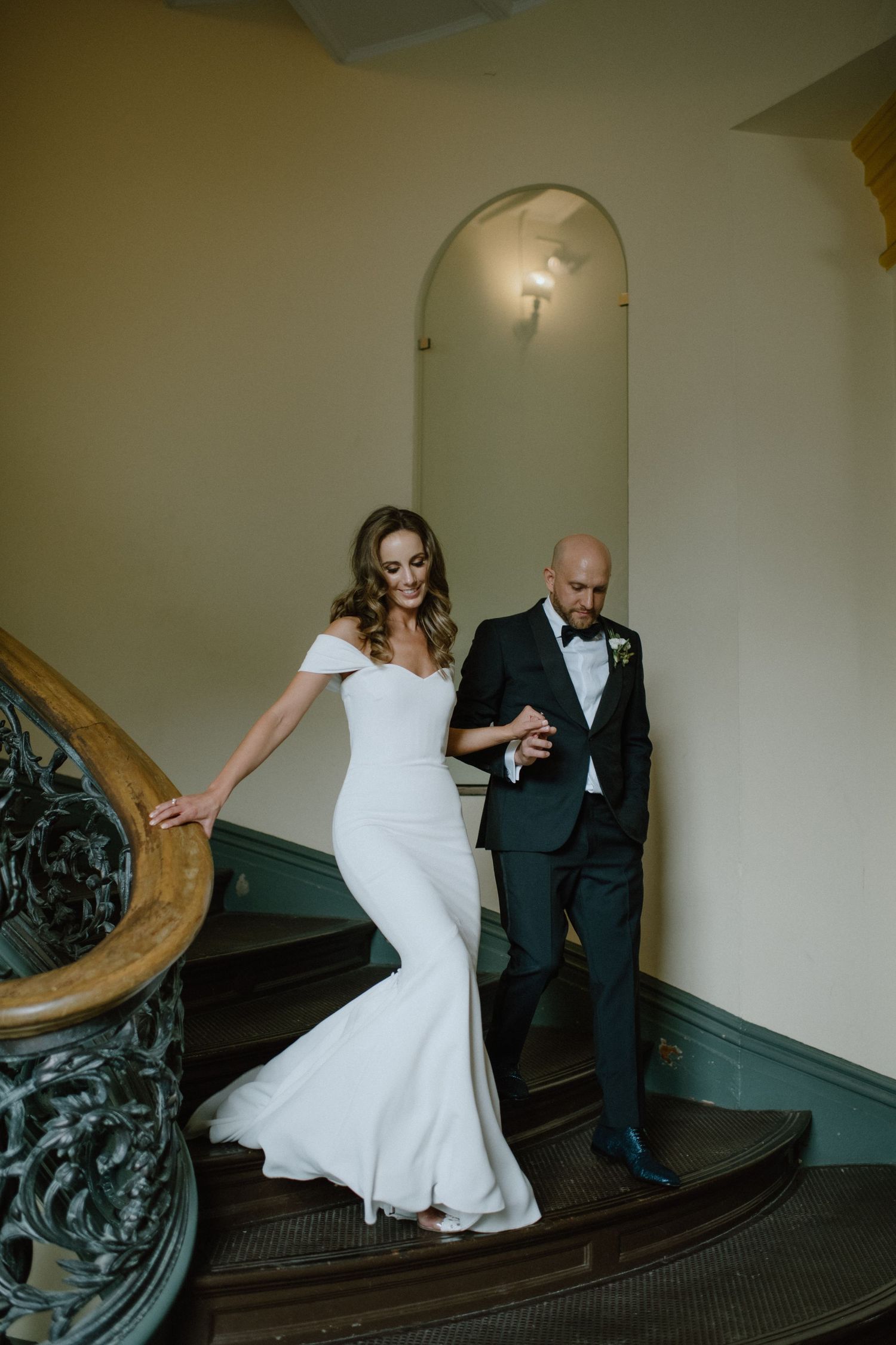 bride and groom walk downstairs