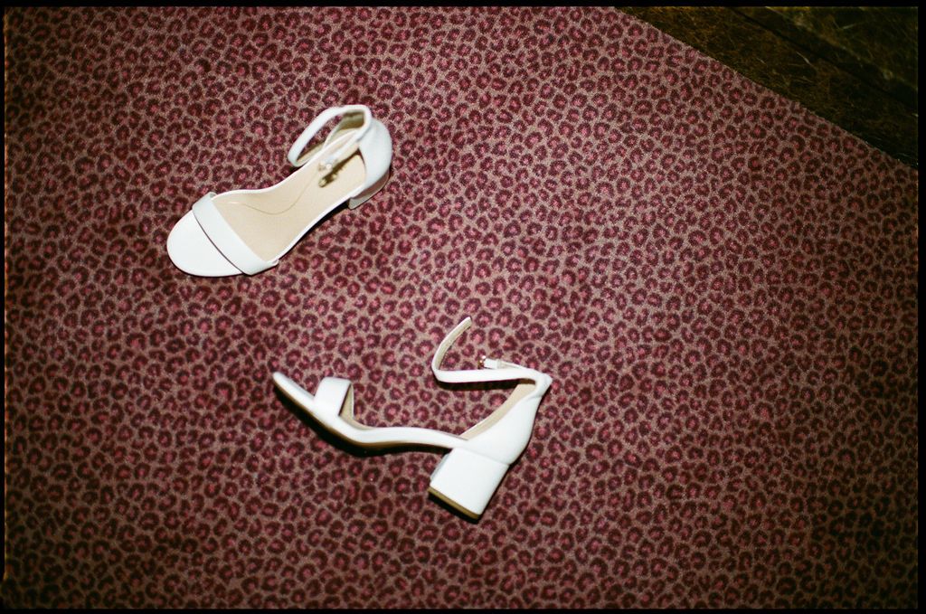 A collection of white Nike sneakers arranged in a row against a dark red textured background.