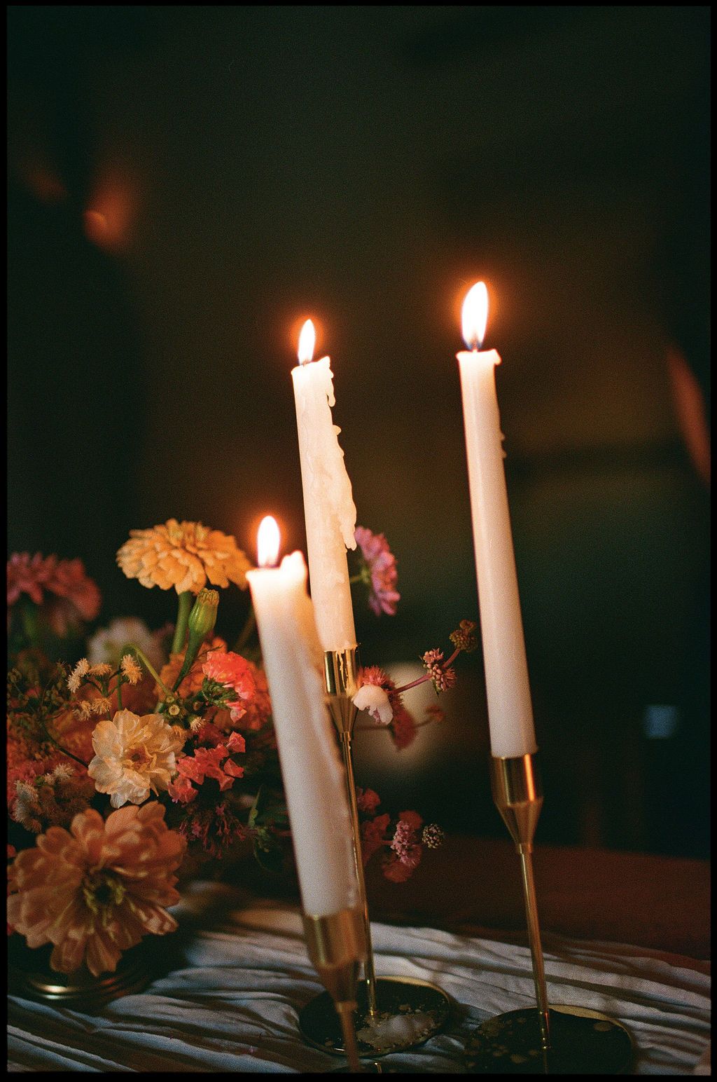 White taper candles and floral arrangements create an elegant table setting Fadensonnon in Baltimore