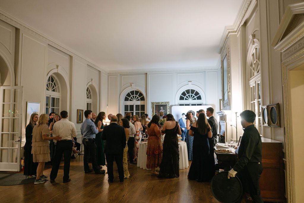 Long elegant hallway with white walls and arched windows at a wedding venue at Strong Mansion on Sugarloaf Mountain