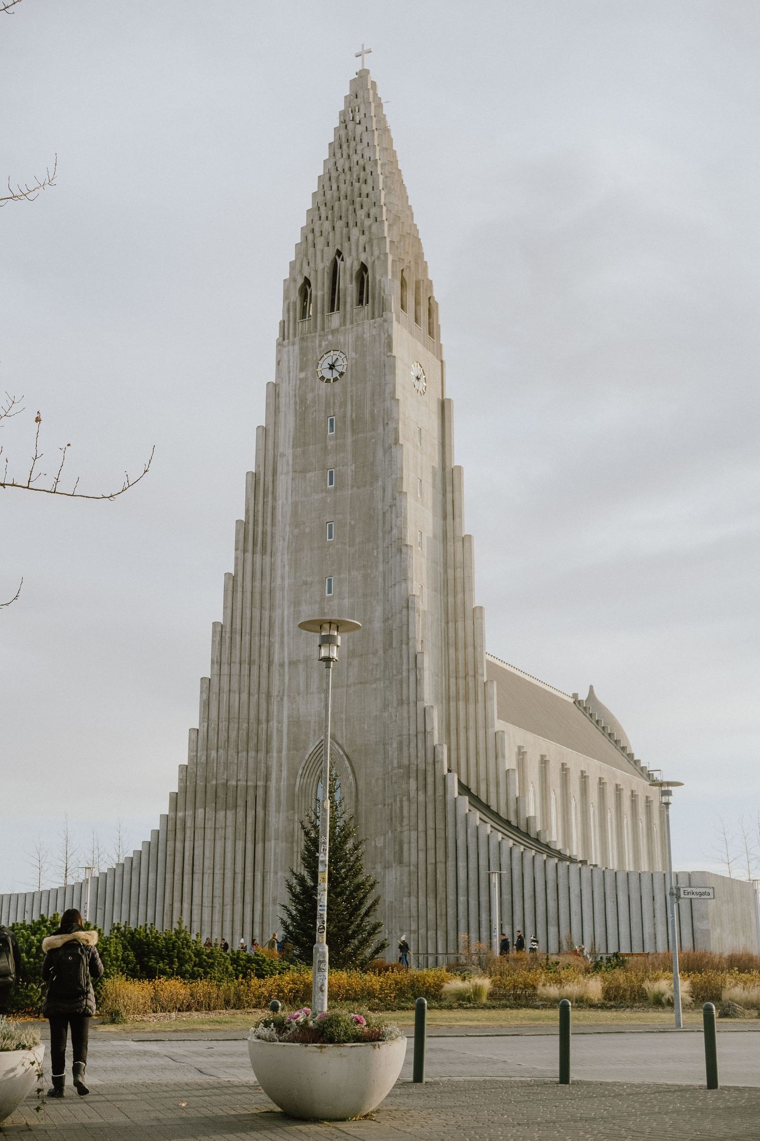 Hallgrímskirkja Lutheran church stands tall with its distinctive stepped architecture against a cloudy sky in Reykjavik, Iceland.