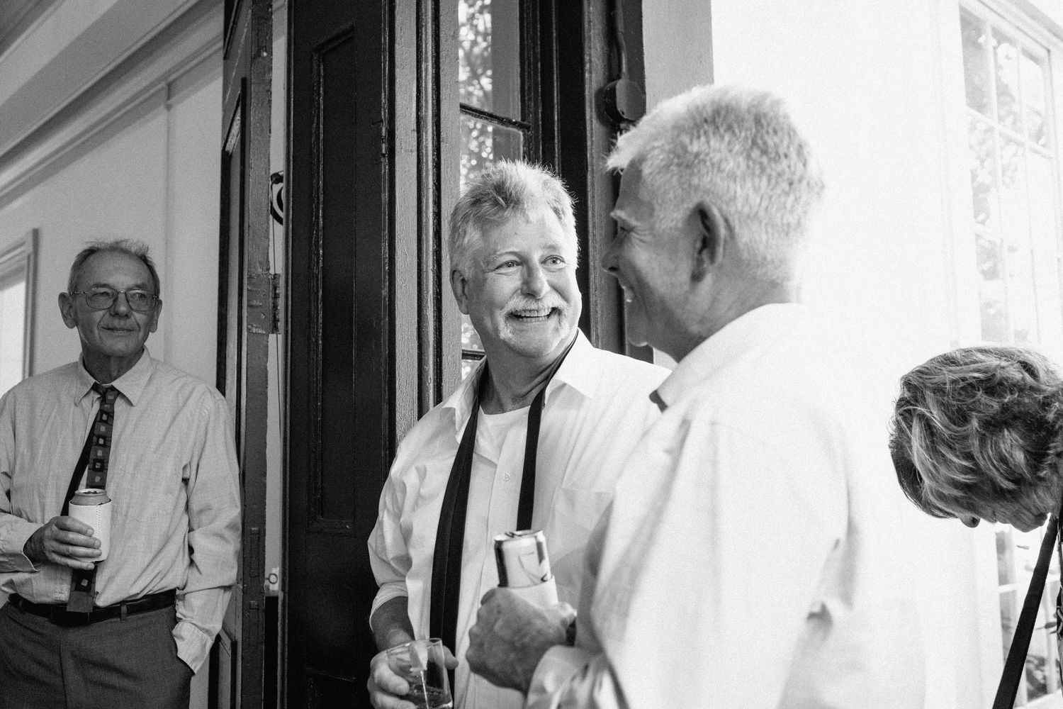 Guests mingling and chatting at an outdoor wedding reception venue.