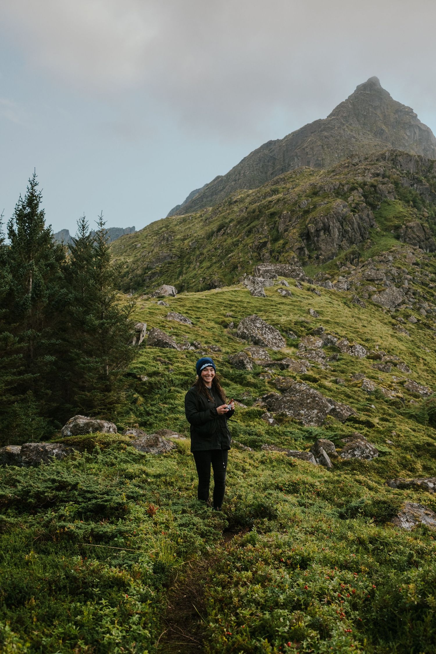 Rugged mountain trail leading to a dramatic rocky peak in the Scottish Highlands.