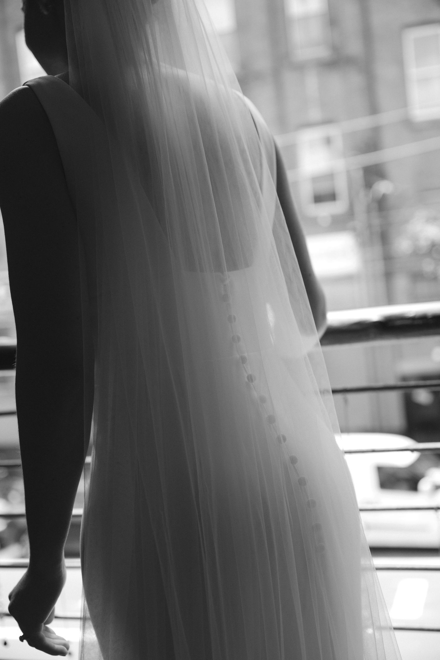 Black and white silhouettes of formal attire create dramatic shadows and shapes.