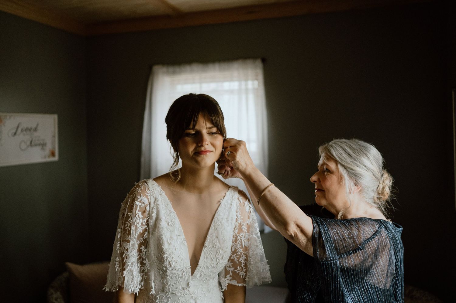 Wedding preparation scene with final touches being made to bridal attire.
