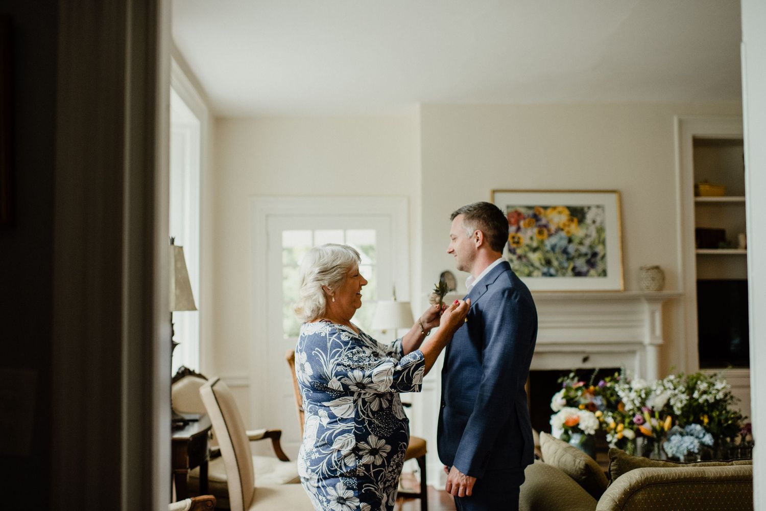 Getting ready scene with formal attire preparations in bright living room.