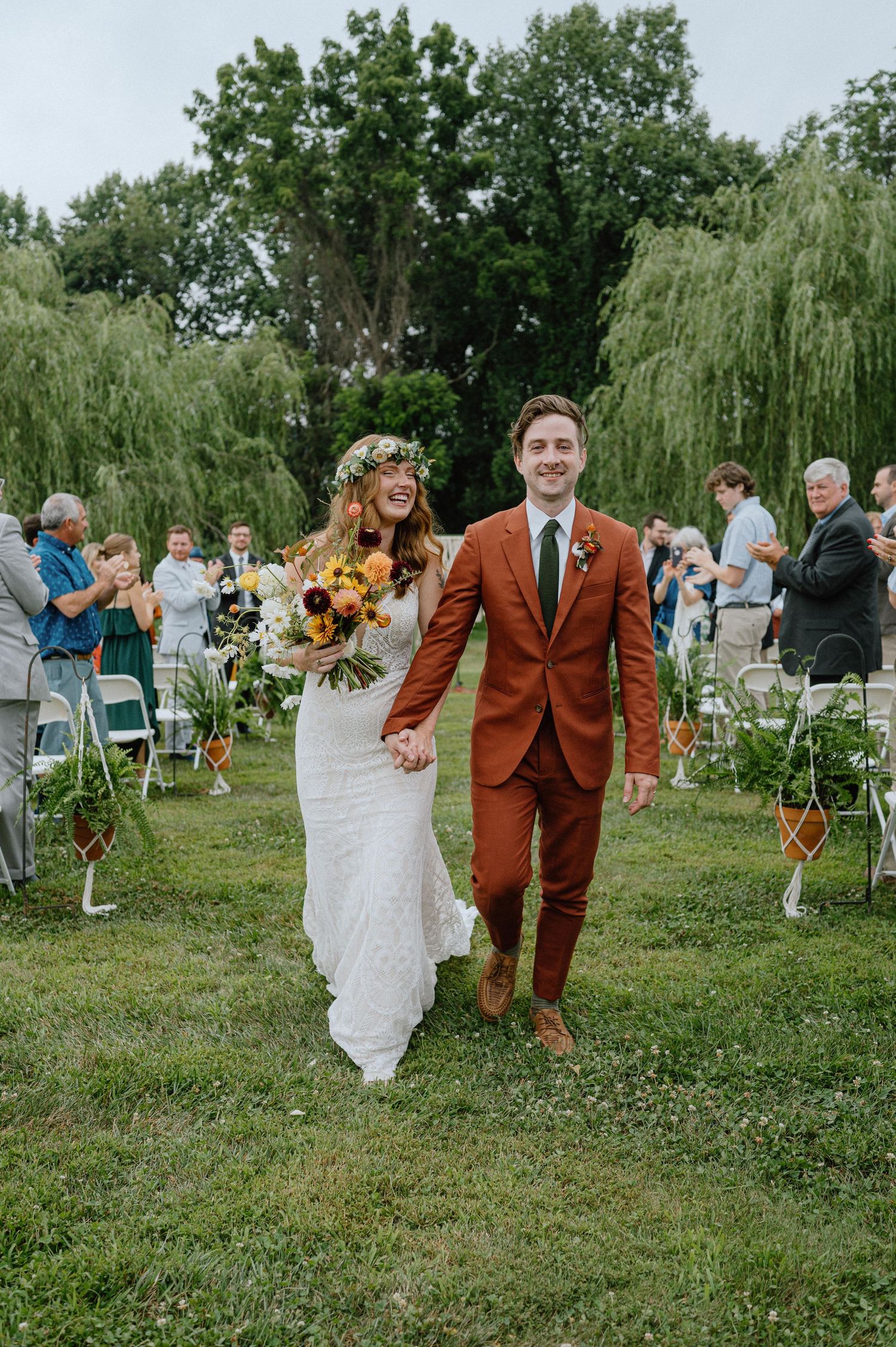 bride and groom happily walk back down asile backyard wedding maryland documentary wedding photographer