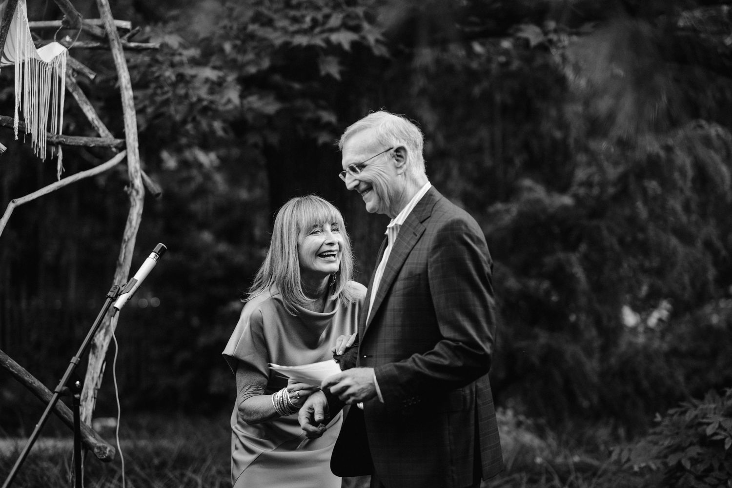 Black and white photo of an emotional moment during an outdoor ceremony.