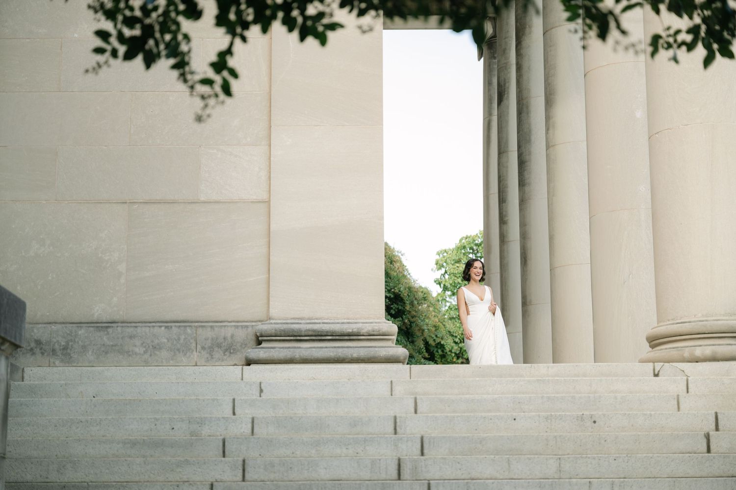 White neoclassical building columns and steps in bright daylight.
