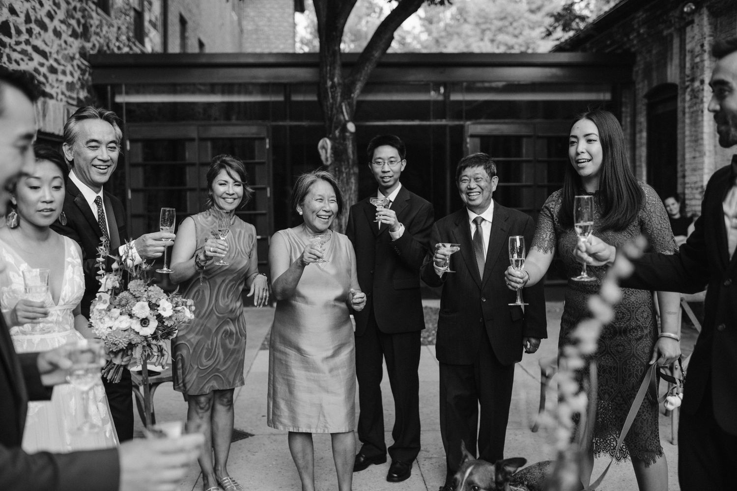 family celebrates with champagne after wedding ceremony