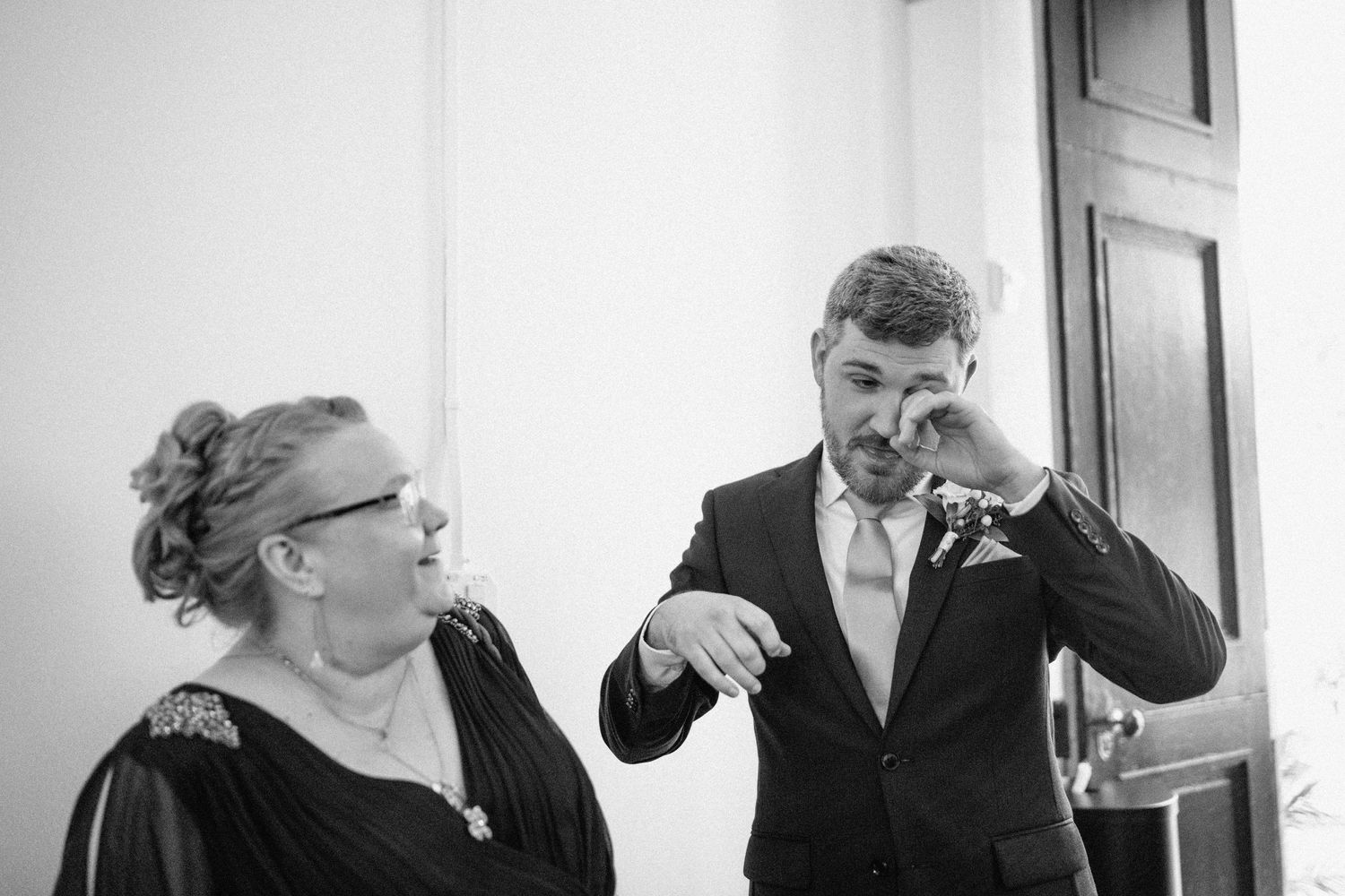 groom wipes tears from eyes