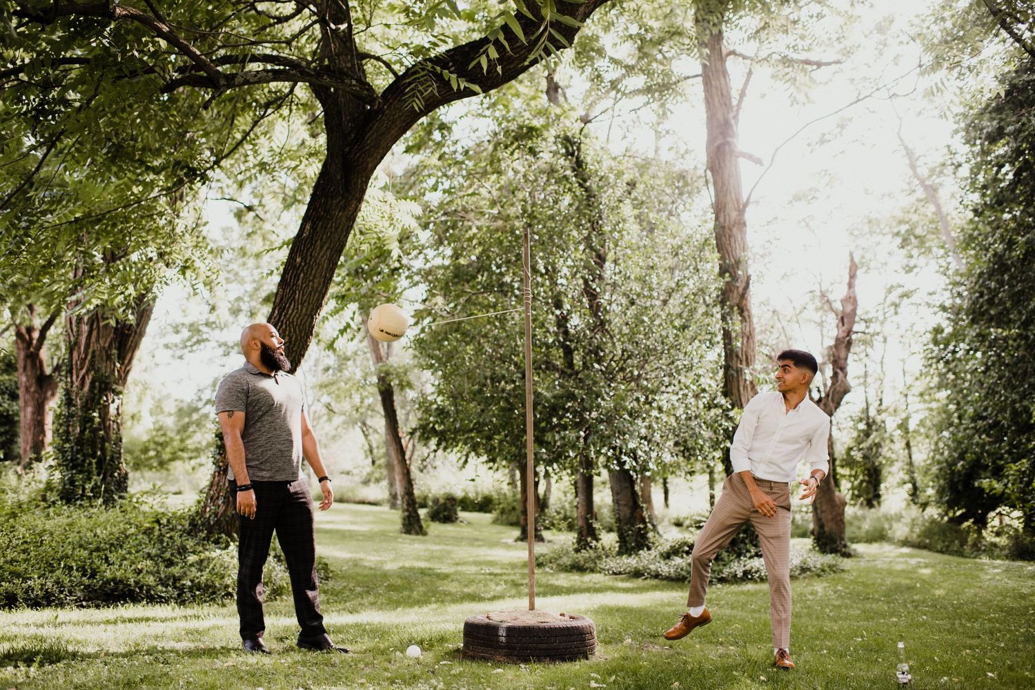 Couple playing games on a lush green lawn during an outdoor celebration.