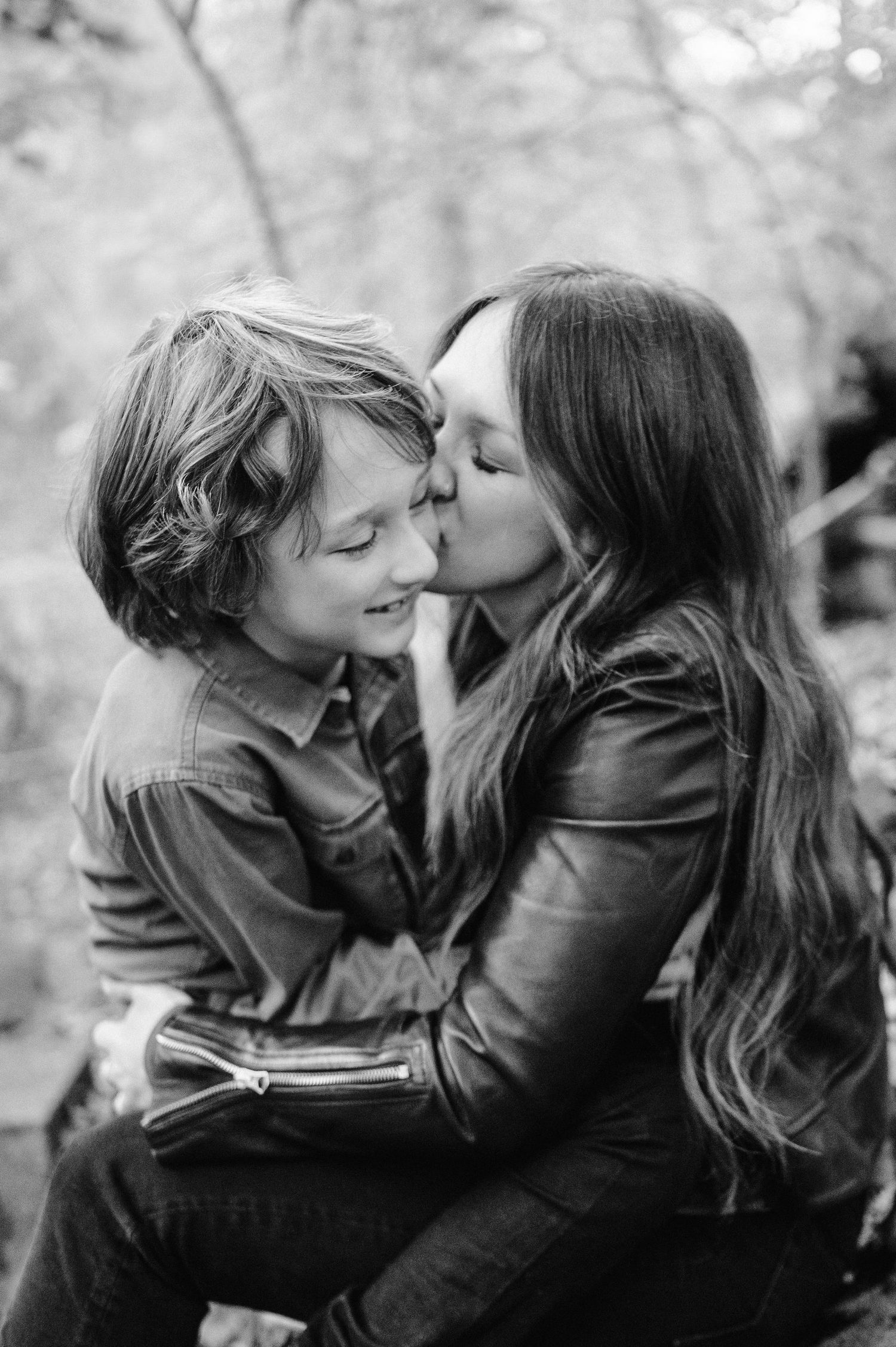 A tender black and white moment shared between parent and child in nature.