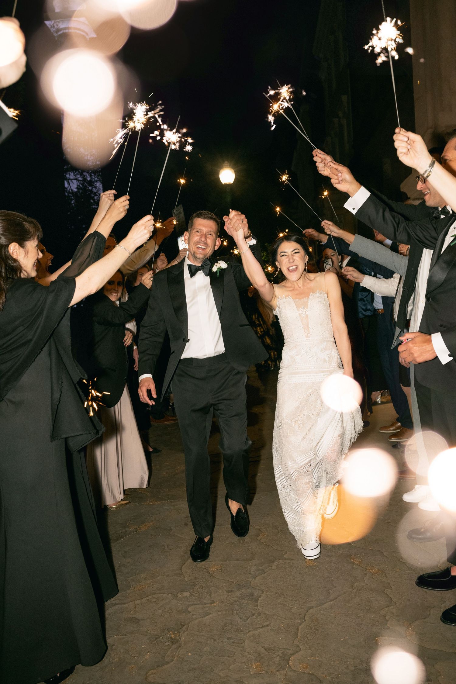 Wedding sparkler exit with guests holding lit sparklers forming tunnel for celebration at baltimore engineers club wedding