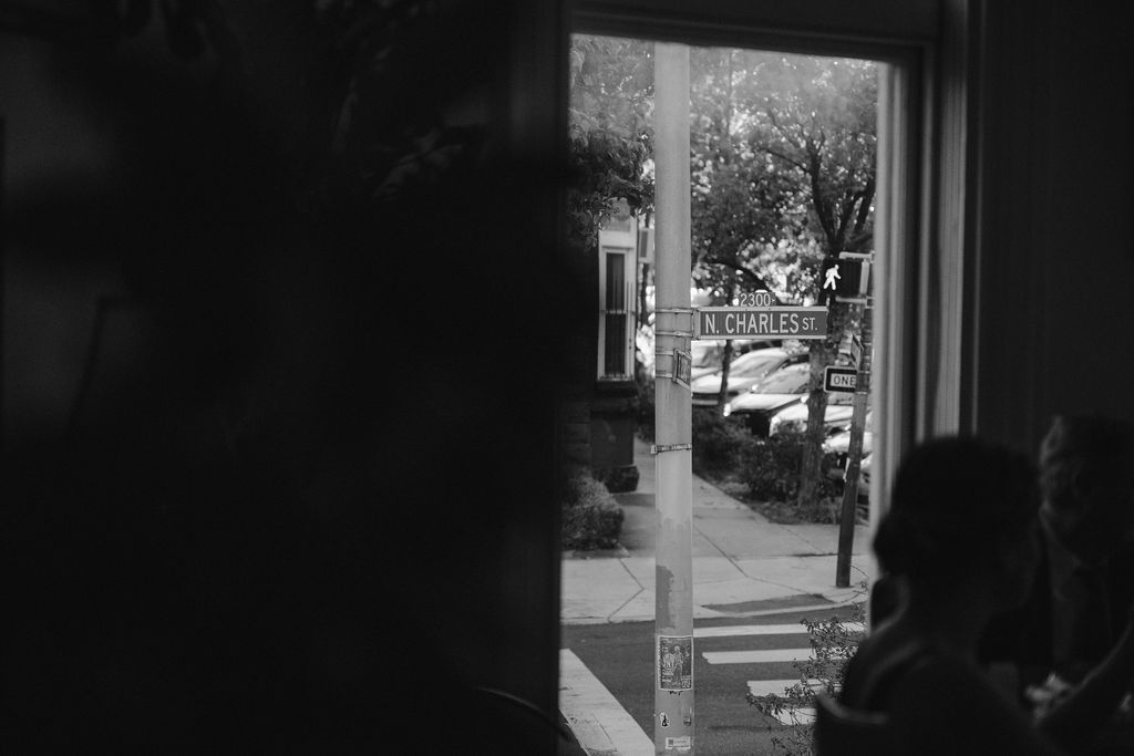 Dark interior view through a window showing bright daylight outside.