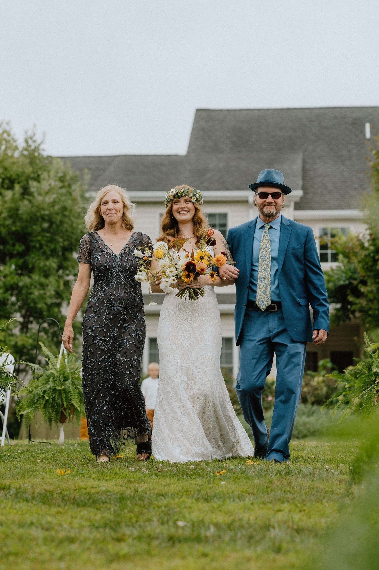 bride walking down the asile boho lace wedding dress flower crown backyard wedding maryland documentary wedding