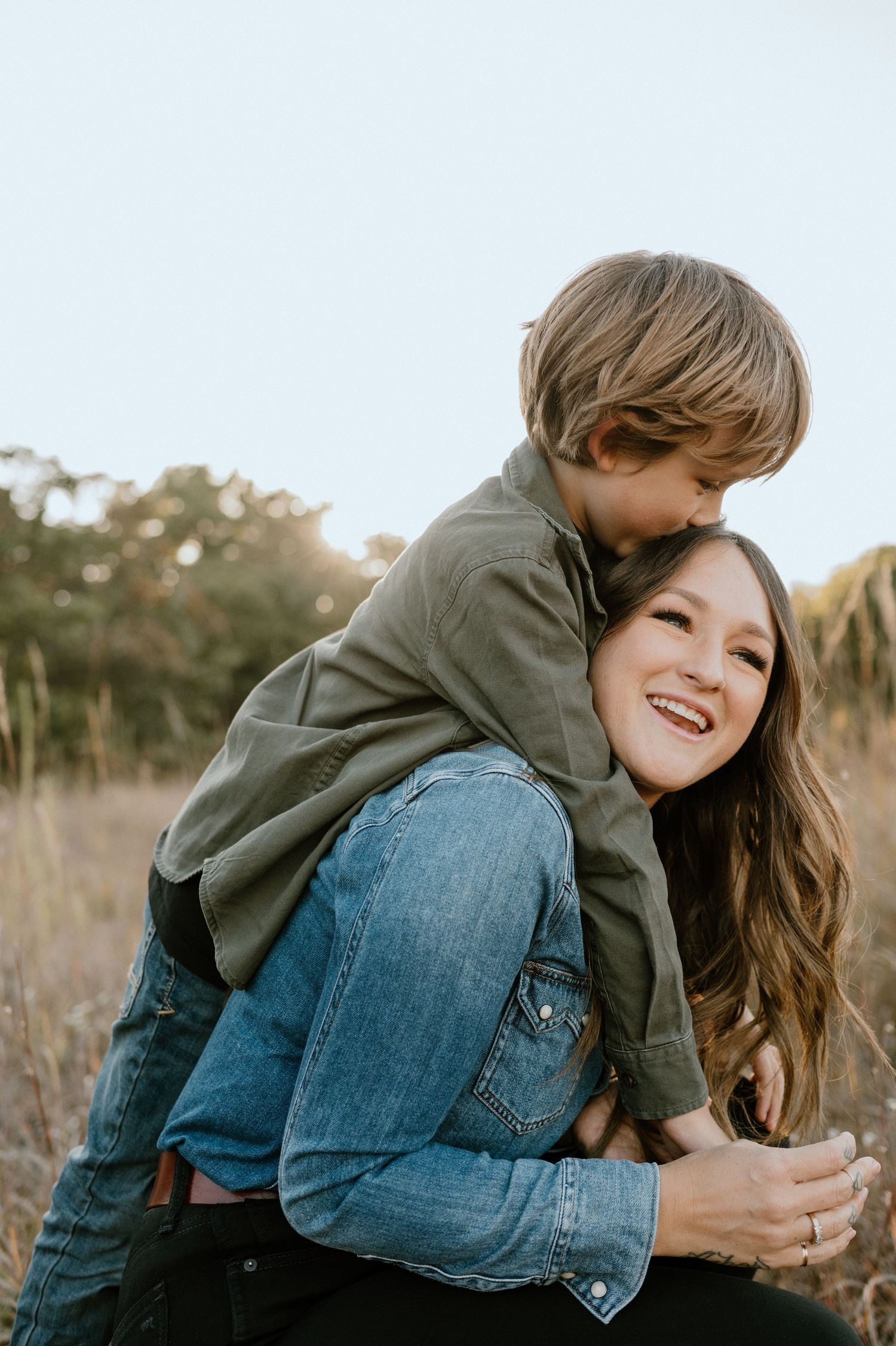 Joyful outdoor family moment captured in warm evening light.