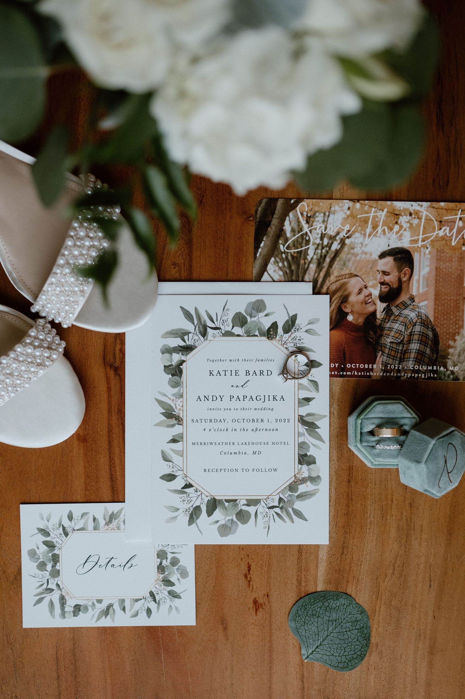 Wedding invitation with floral design displayed with white shoes and engagement photo.