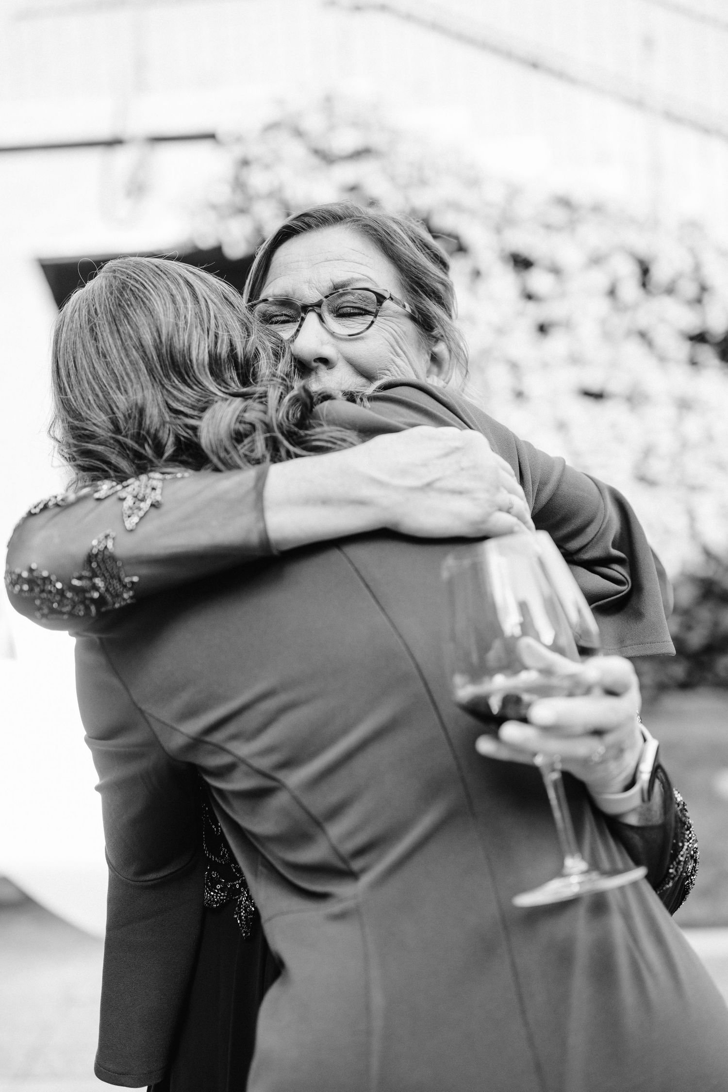 A warm embrace shared between two people during a celebration.