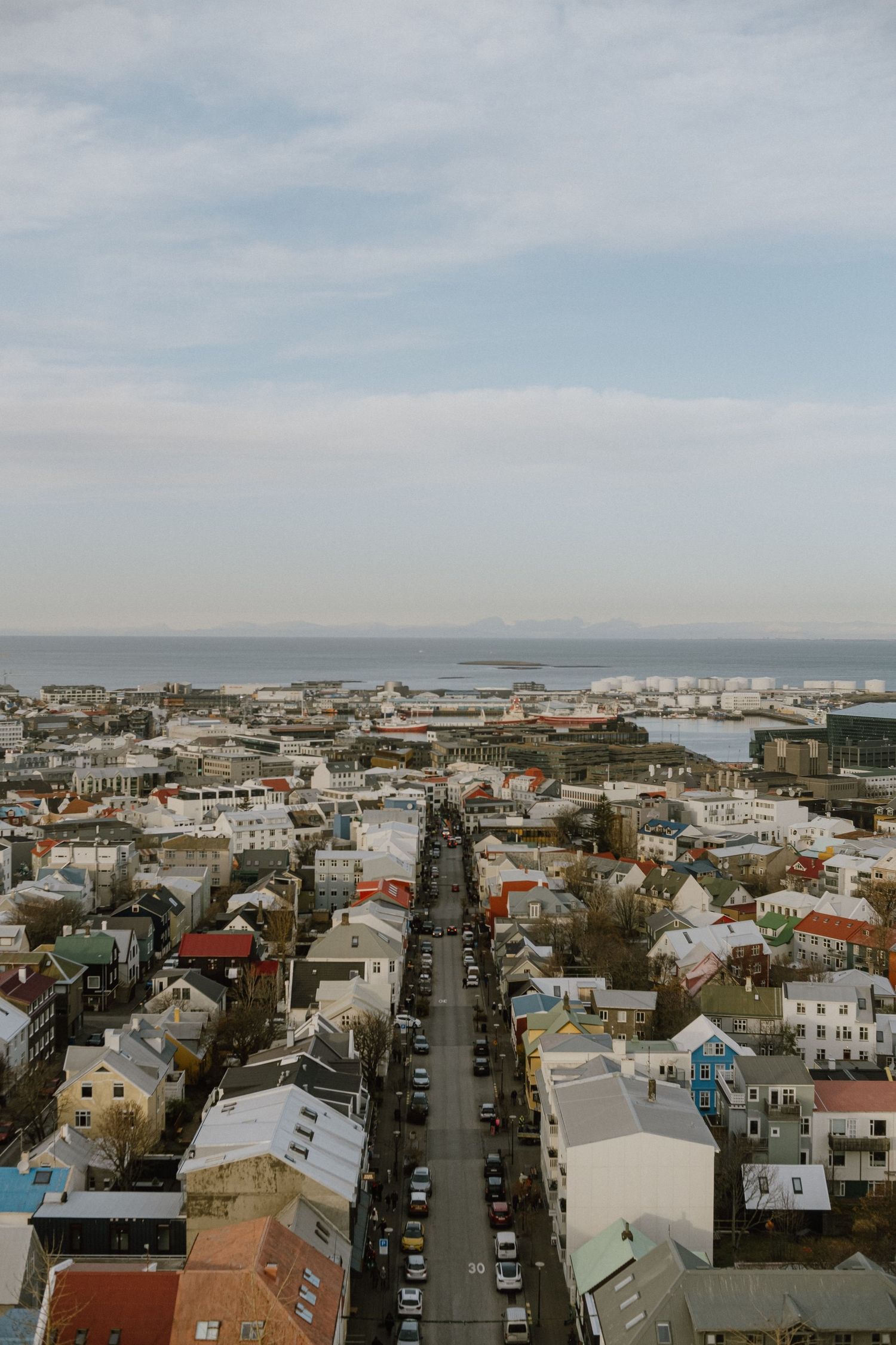 Bird's eye view of downtown Reykjavik showing grid streets and traditional Nordic houses stretching towards the harbor.