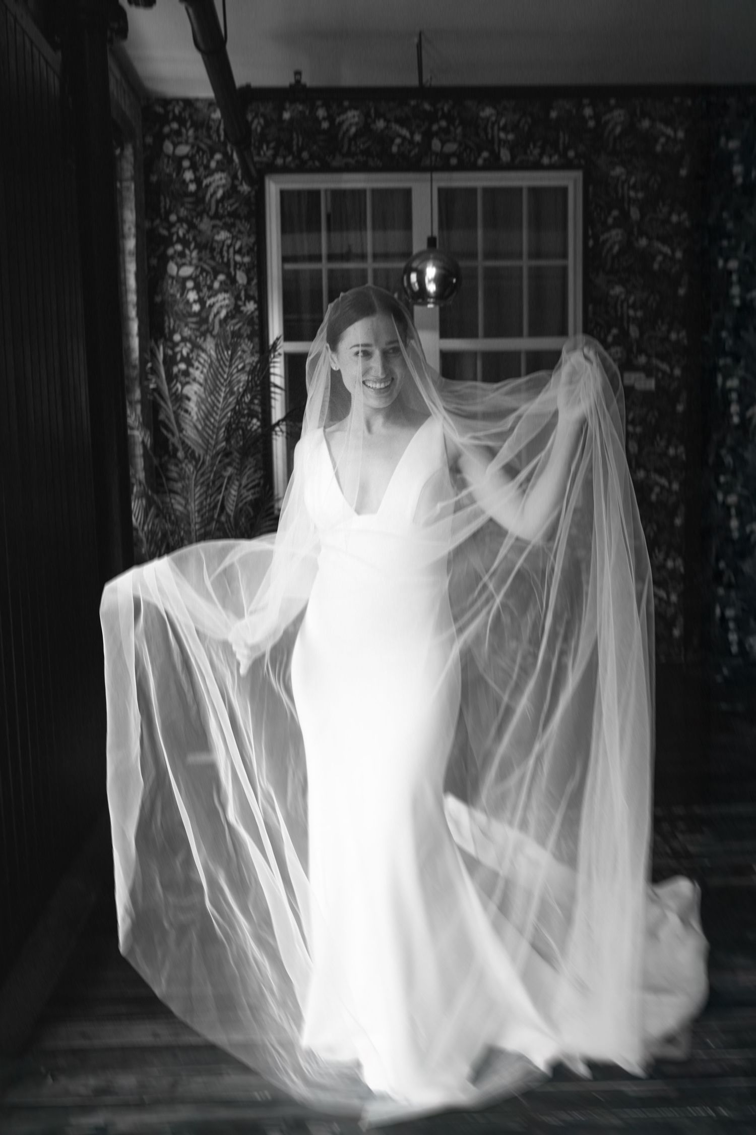 Ethereal sequence of a figure in white flowing fabric creating ghost-like movements against a dark background.