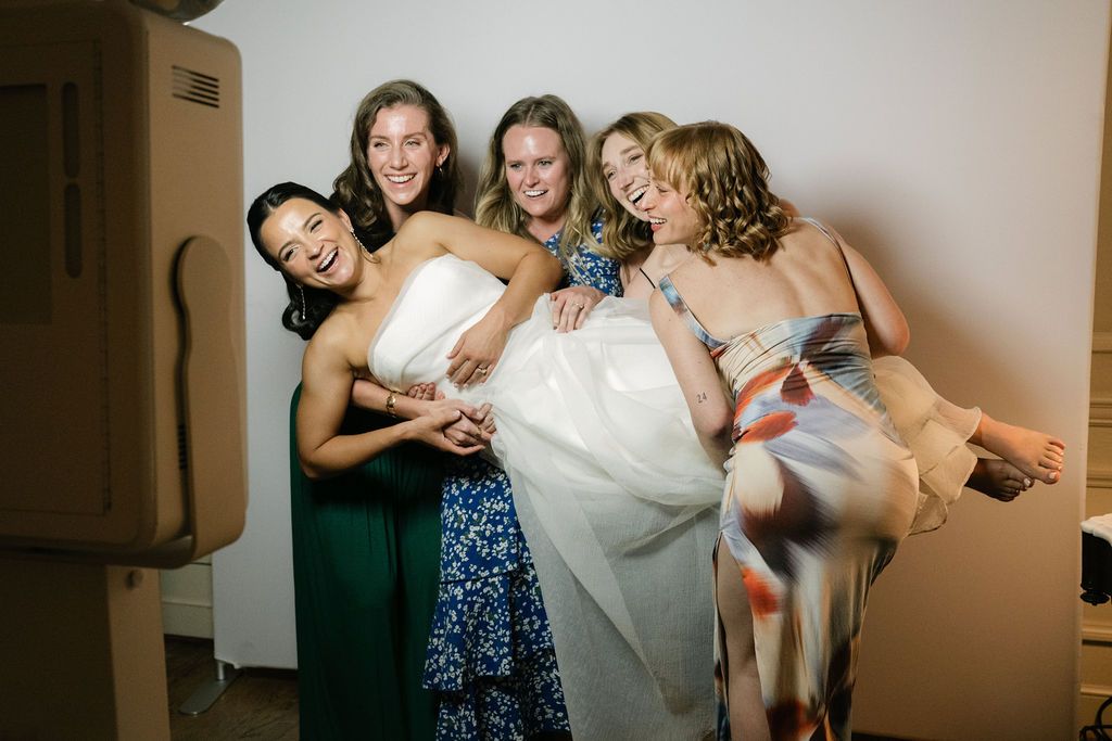 Group of wedding guests dancing and posing together at a celebration at Strong Mansion on Sugarloaf Mountain