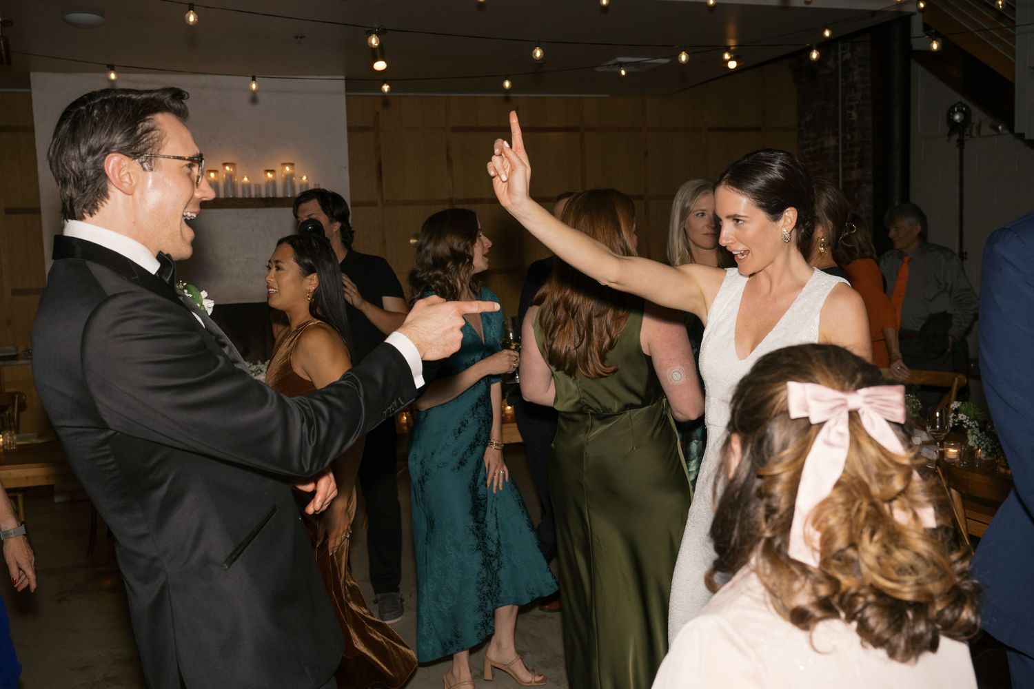 Wedding celebration showing dancing and festivities on the dance floor.