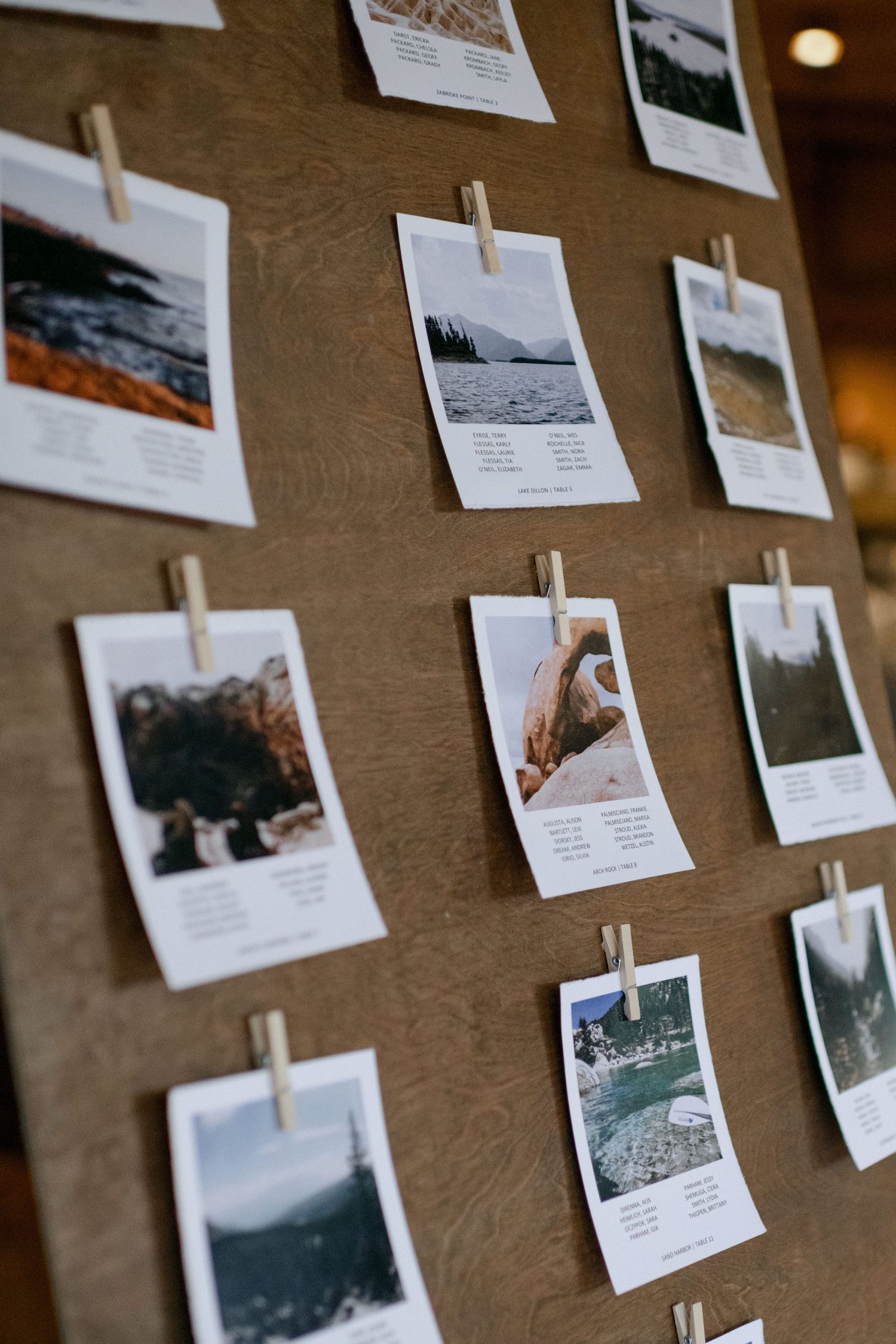 Polaroid-style photos displayed on a brown wall with wooden clothespins showing landscape scenes.