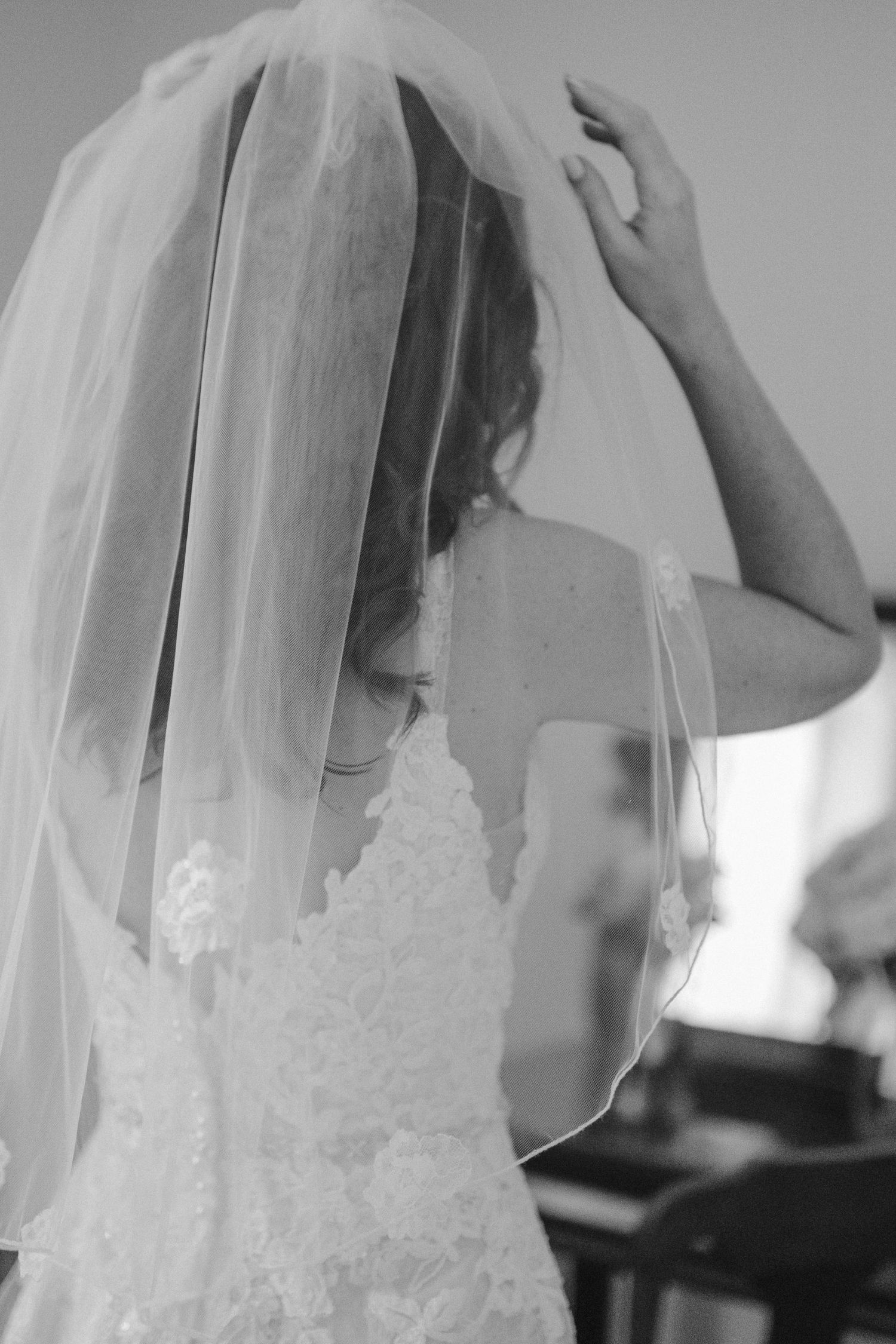 bride putting on veil