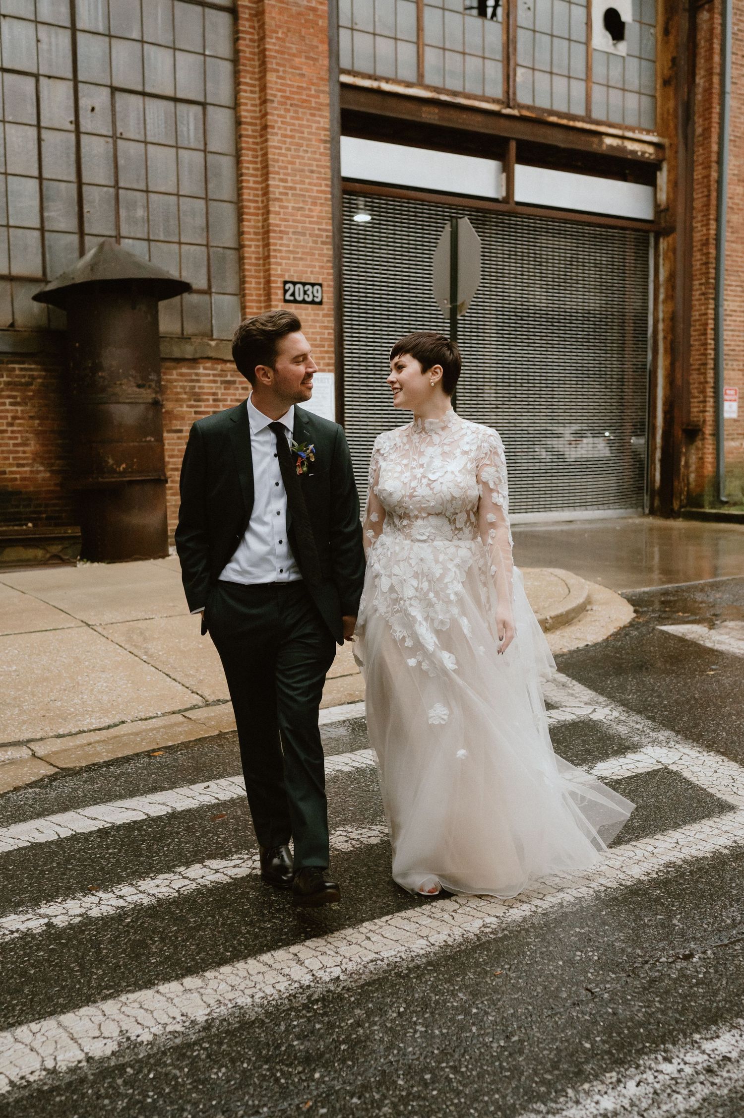 couple walks across street in clipper mill baltimore