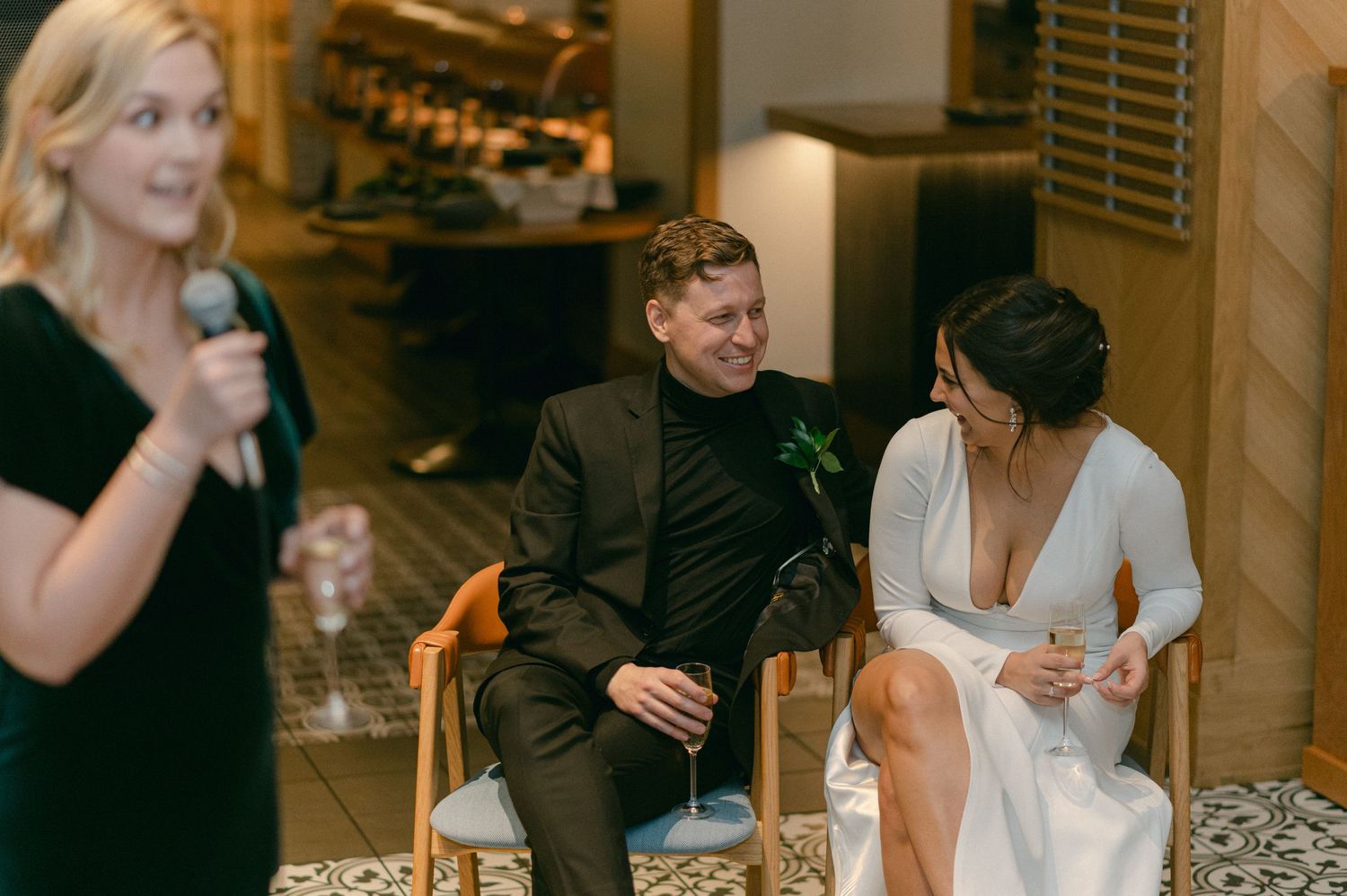 Guests celebrating at an elegant indoor event with champagne.
